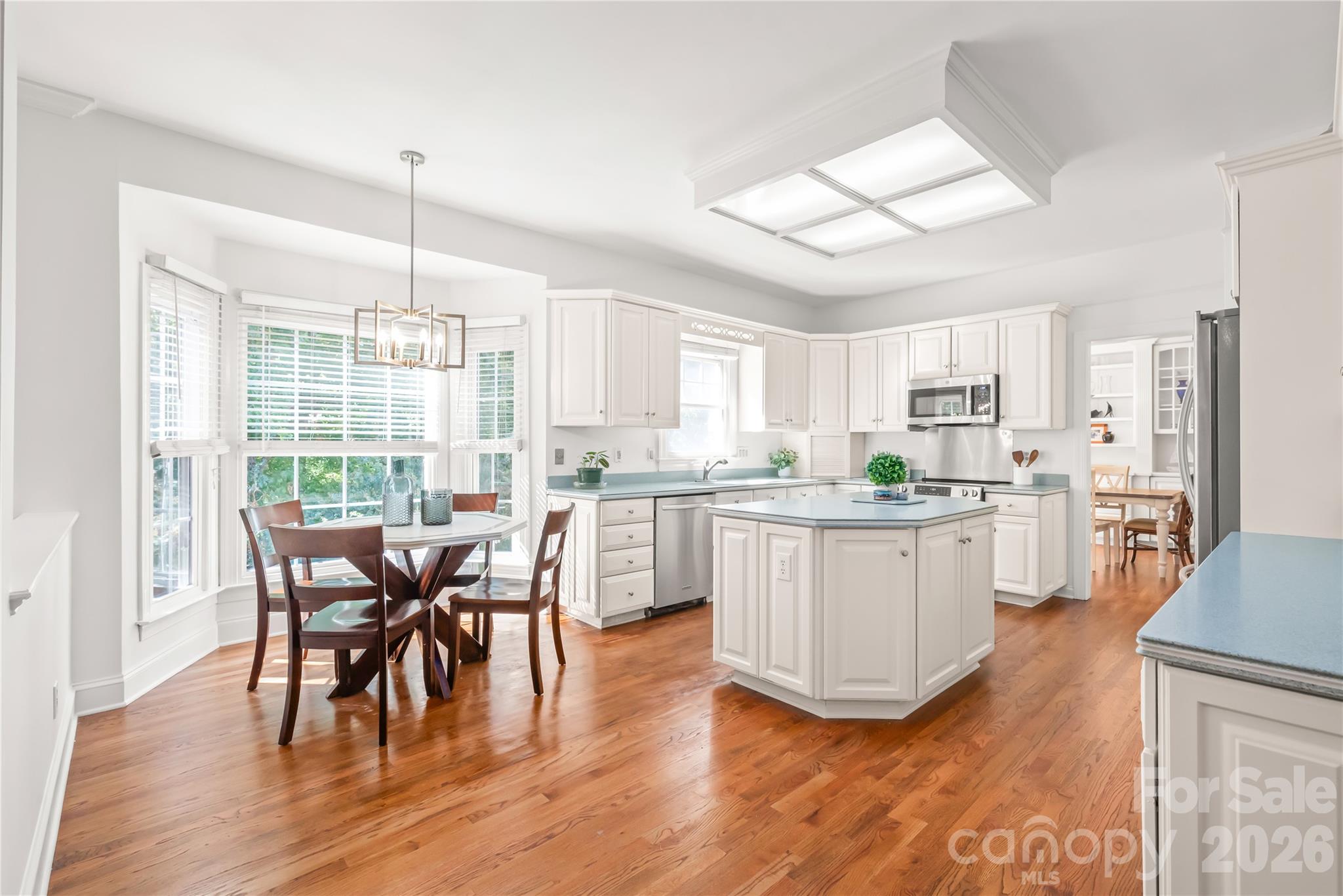 A spacious chef’s kitchen paired with a sunlit breakfast nook and bay window...perfect for quiet morning coffee and casual daily meals. - 11024 Stonepath Lane, Charlotte
