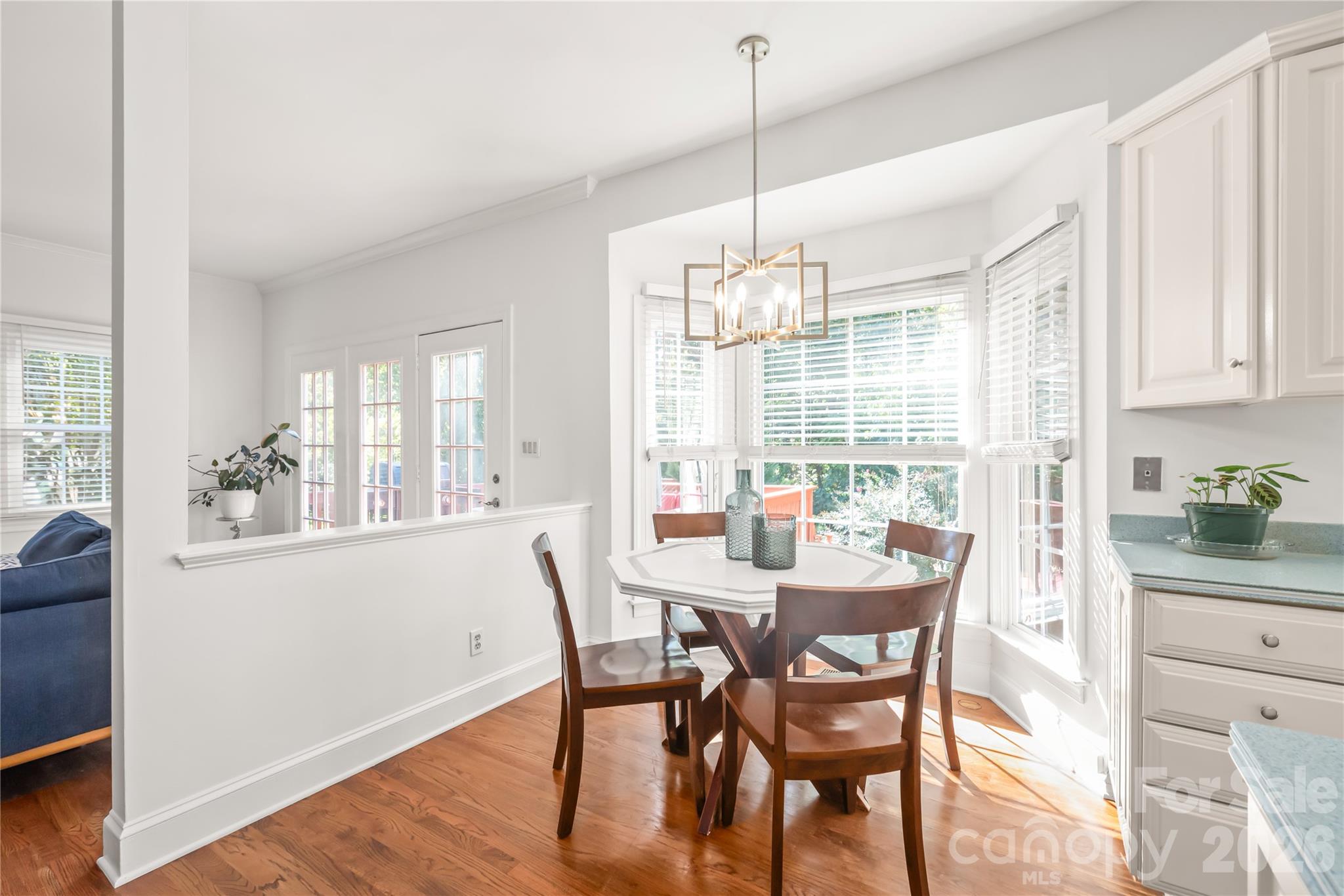 The sunlit breakfast nook features a charming bay window overlooking the serene, private backyard. - 11024 Stonepath Lane, Charlotte