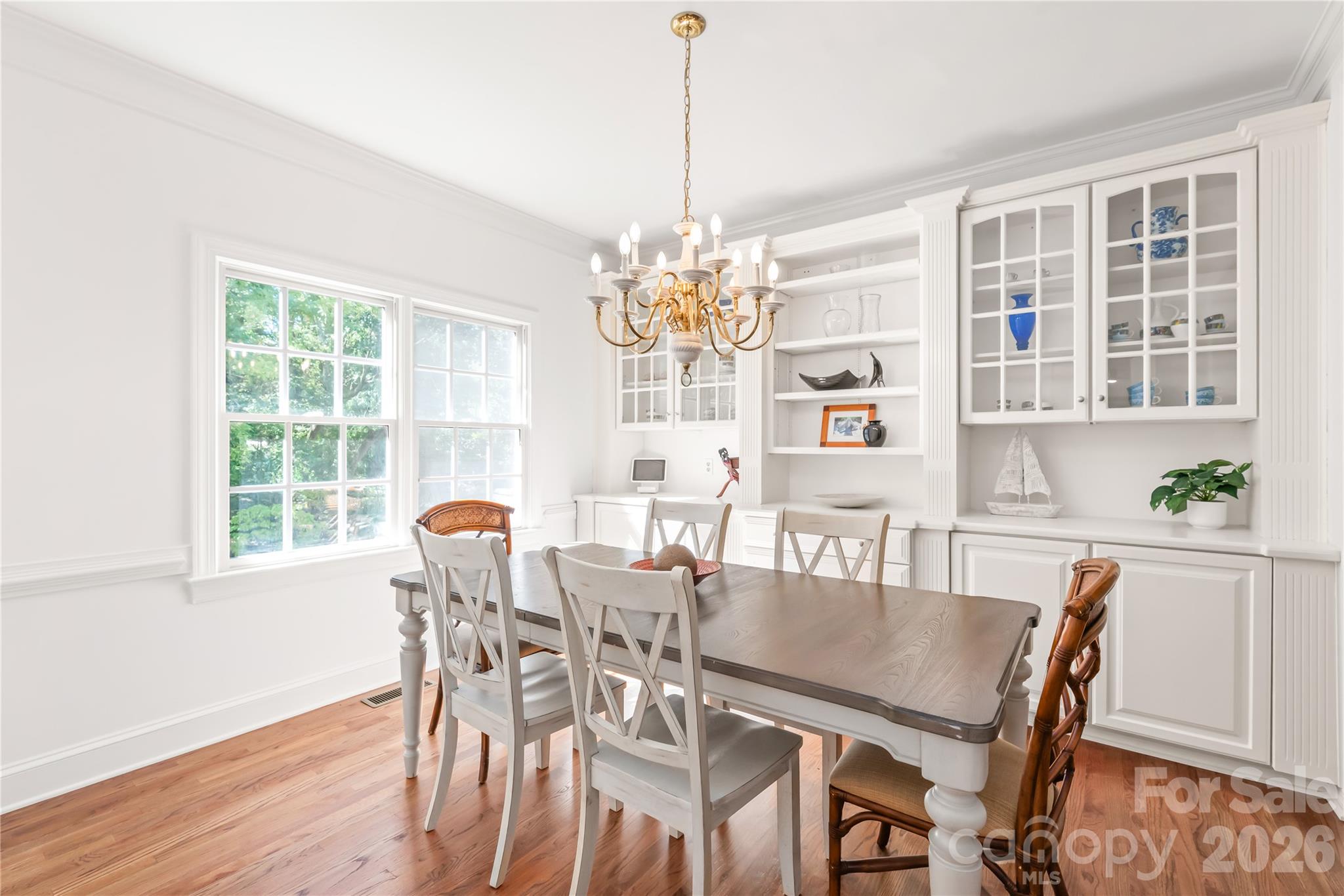 These built-ins pair ample closed storage below with illuminated glass-front cabinets above to showcase your favorite dinnerware and decor. - 11024 Stonepath Lane, Charlotte