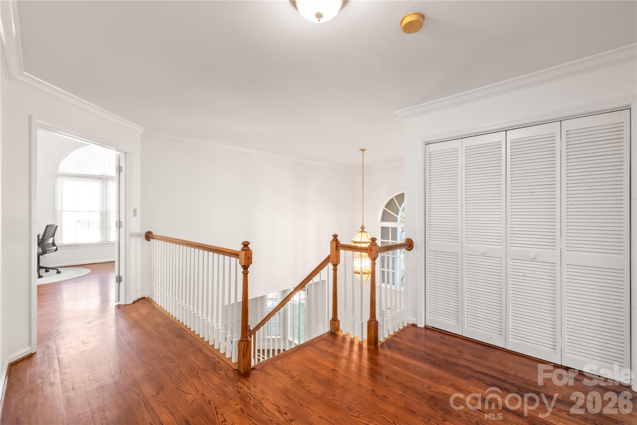Second level features features hardwood floors and the home’s primary laundry area, making daily routines effortless right near the bedrooms. - 11024 Stonepath Lane, Charlotte