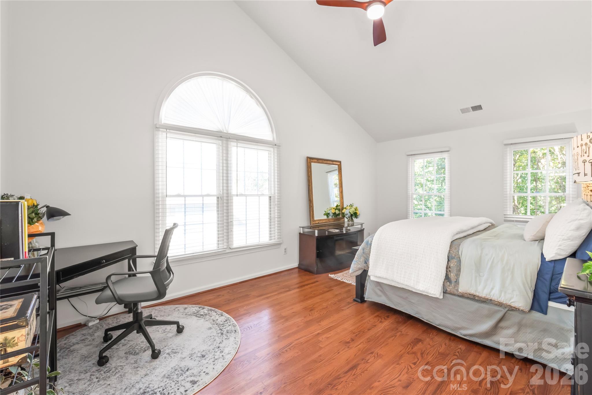 Crisp and effortlessly...the primary retreat pairs rich hardwood floors with fresh, neutral paint to create the ultimate restful escape. - 11024 Stonepath Lane, Charlotte