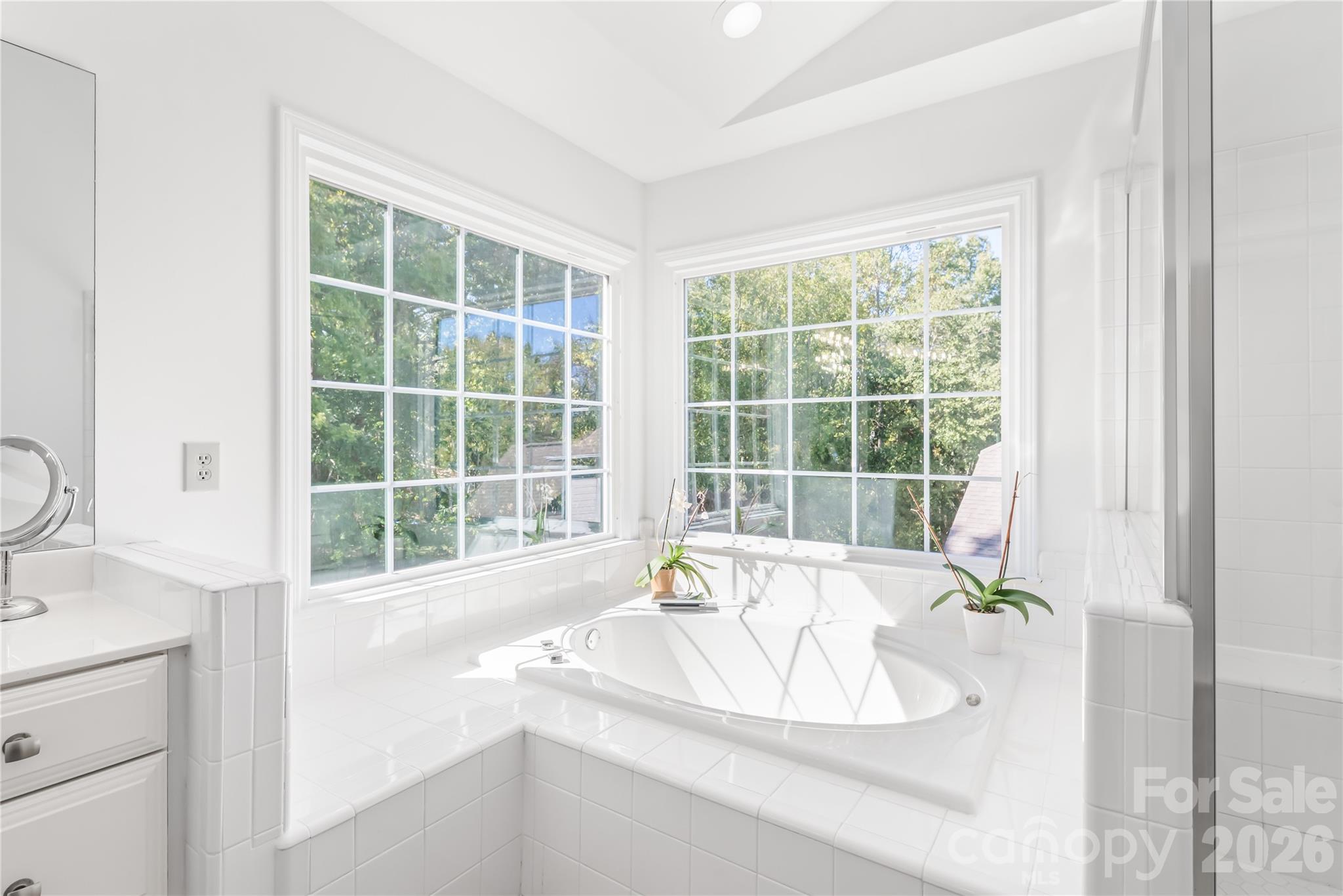 Enjoy bright, natural light paired with a peaceful, scenic backdrop of the lush wooded backyard. - 11024 Stonepath Lane, Charlotte