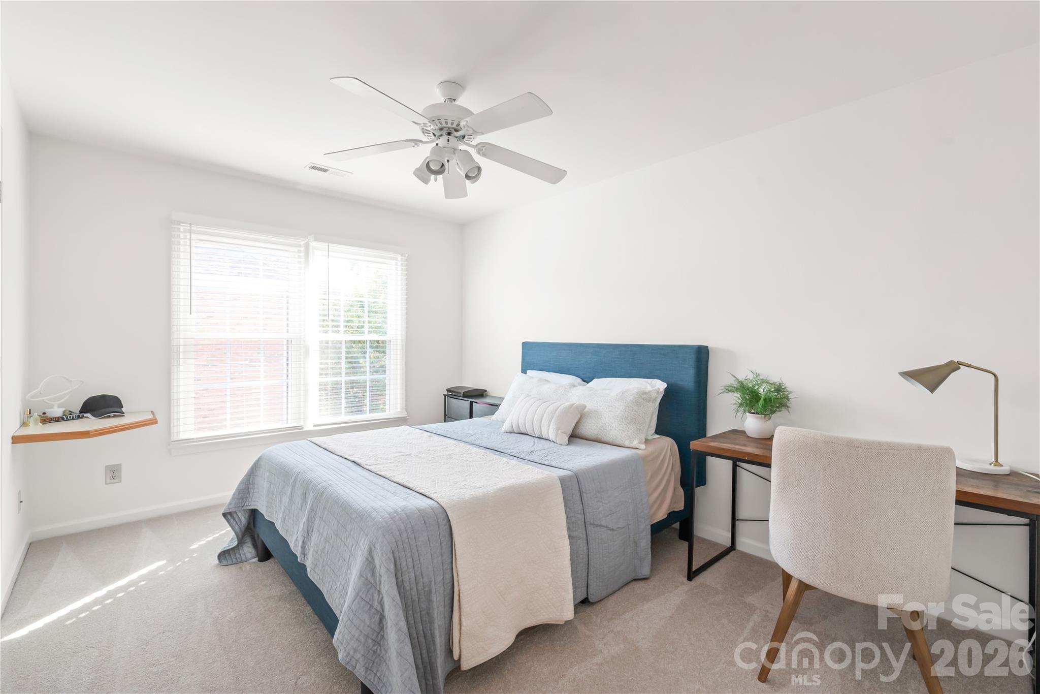 Bedroom two offers plush new carpet (2026) and clean, neutral paint for an instantly cozy, move-in-ready space. - 11024 Stonepath Lane, Charlotte