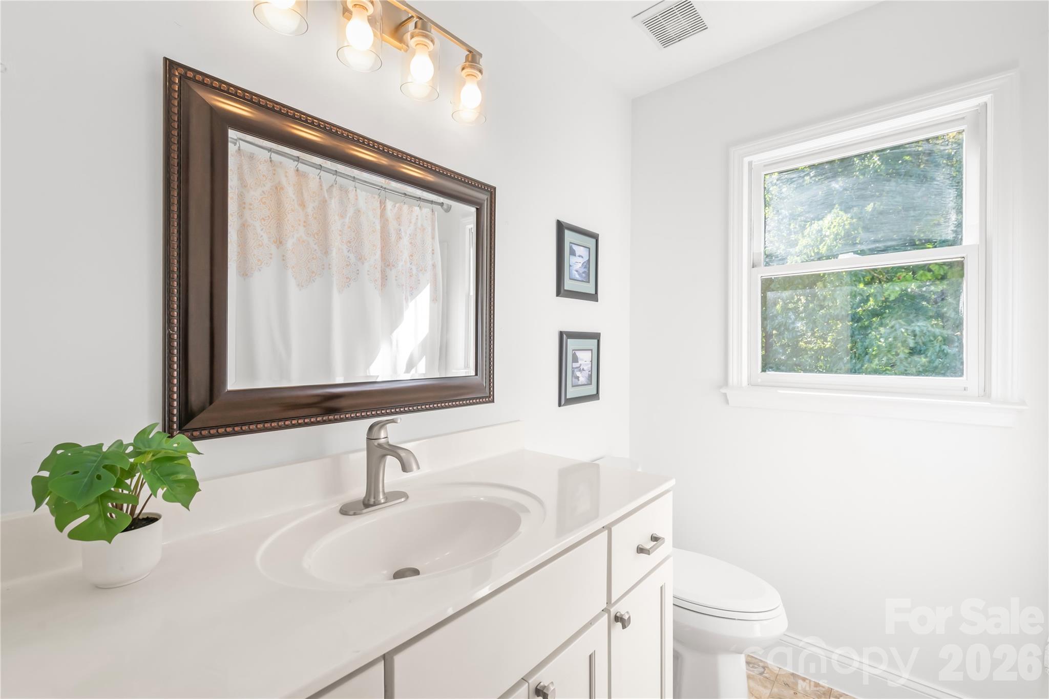 Conveniently located to serve the secondary bedrooms...this full bath features a tub/shower combo and updated lighting. - 11024 Stonepath Lane, Charlotte