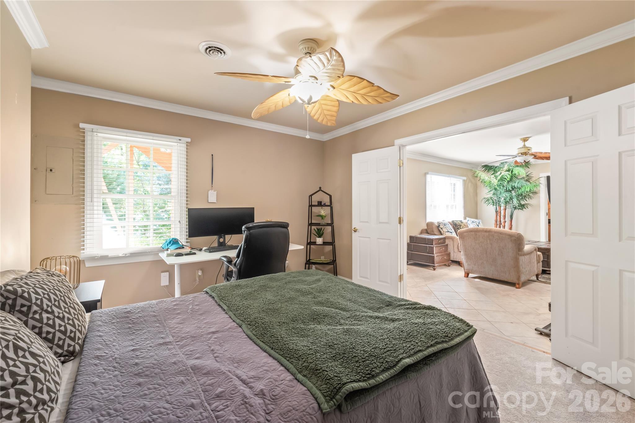 The fifth bedroom connects to the lower-level living area through French doors, easily functioning as a private guest suite or an airy flex space. - 11024 Stonepath Lane, Charlotte