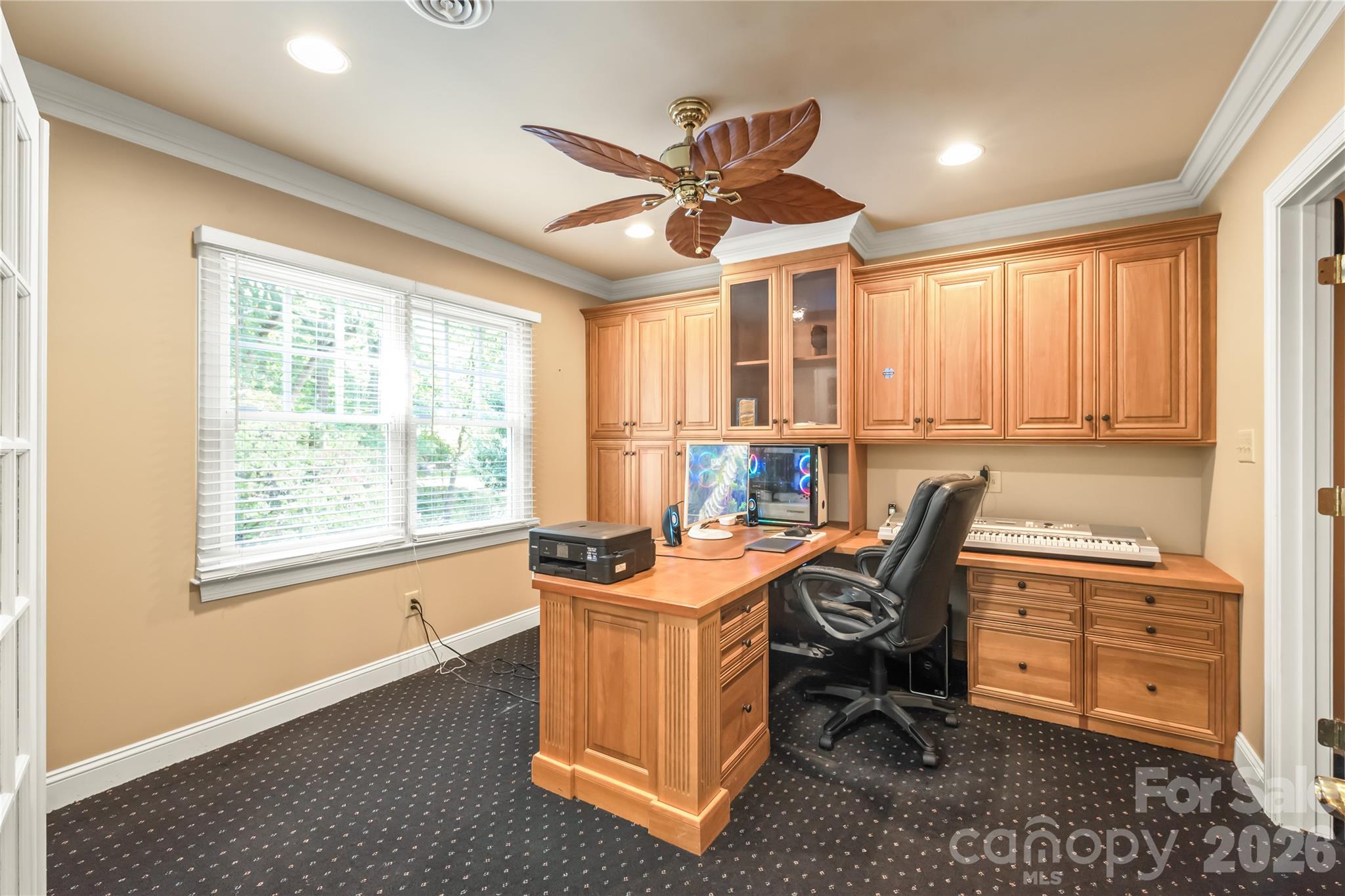 The ultimate work-from-home setup...this quiet lower-level office features built-in cabinetry and a dedicated desk for seamless productivity. - 11024 Stonepath Lane, Charlotte