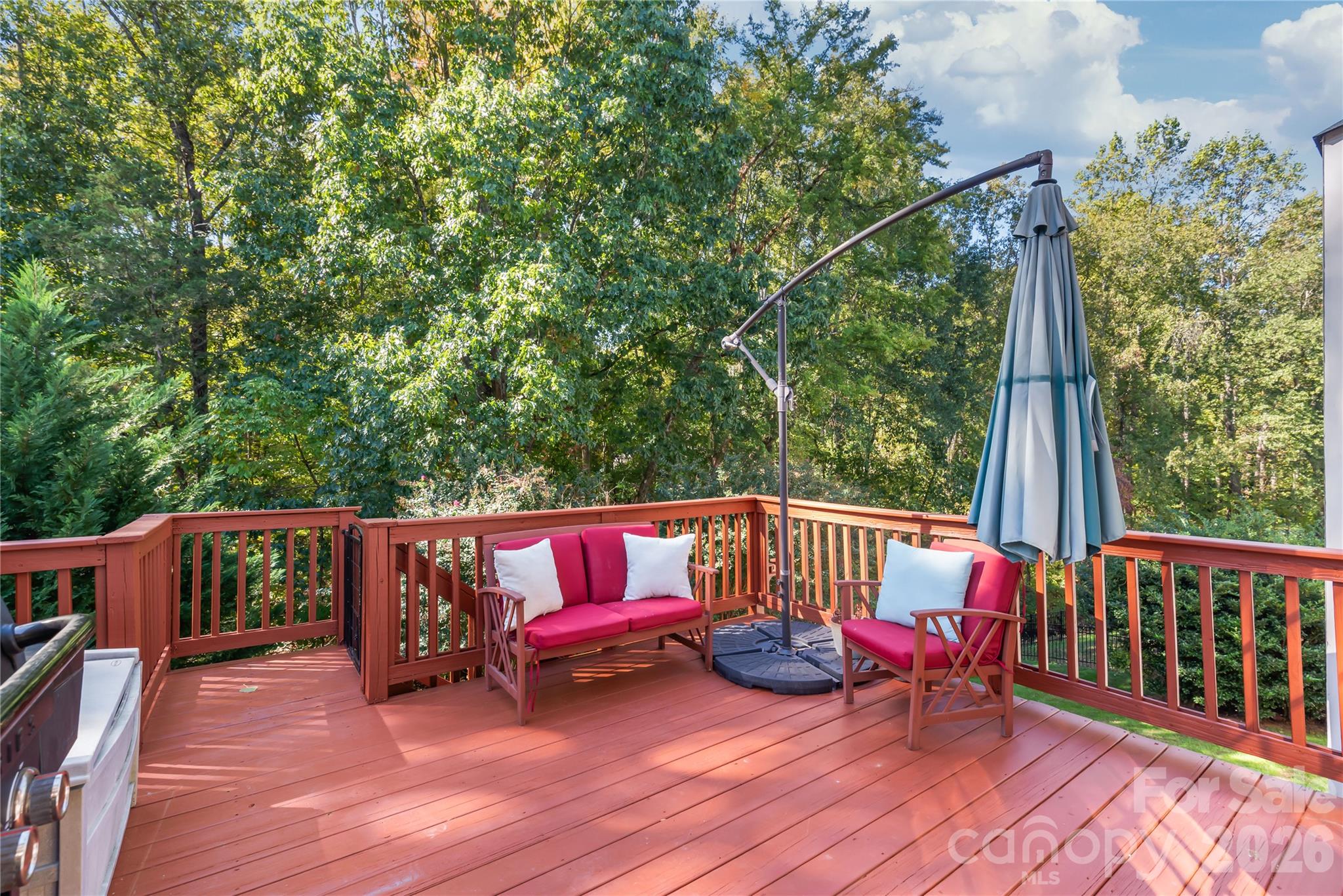 Step outside to the freshly painted deck...the perfect elevated perch for morning coffee, evening cookouts, and soaking in the tranquil views of the private backyard. - 11024 Stonepath Lane, Charlotte