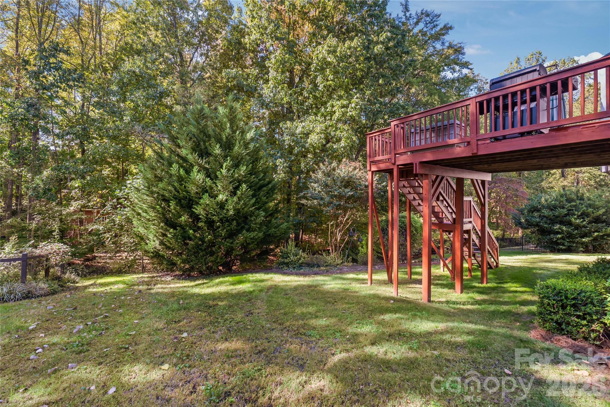 Your private outdoor sanctuary...the lush, tree-lined backyard offers peaceful seclusion, green space to play or unwind, and a tranquil wooded backdrop. - 11024 Stonepath Lane, Charlotte