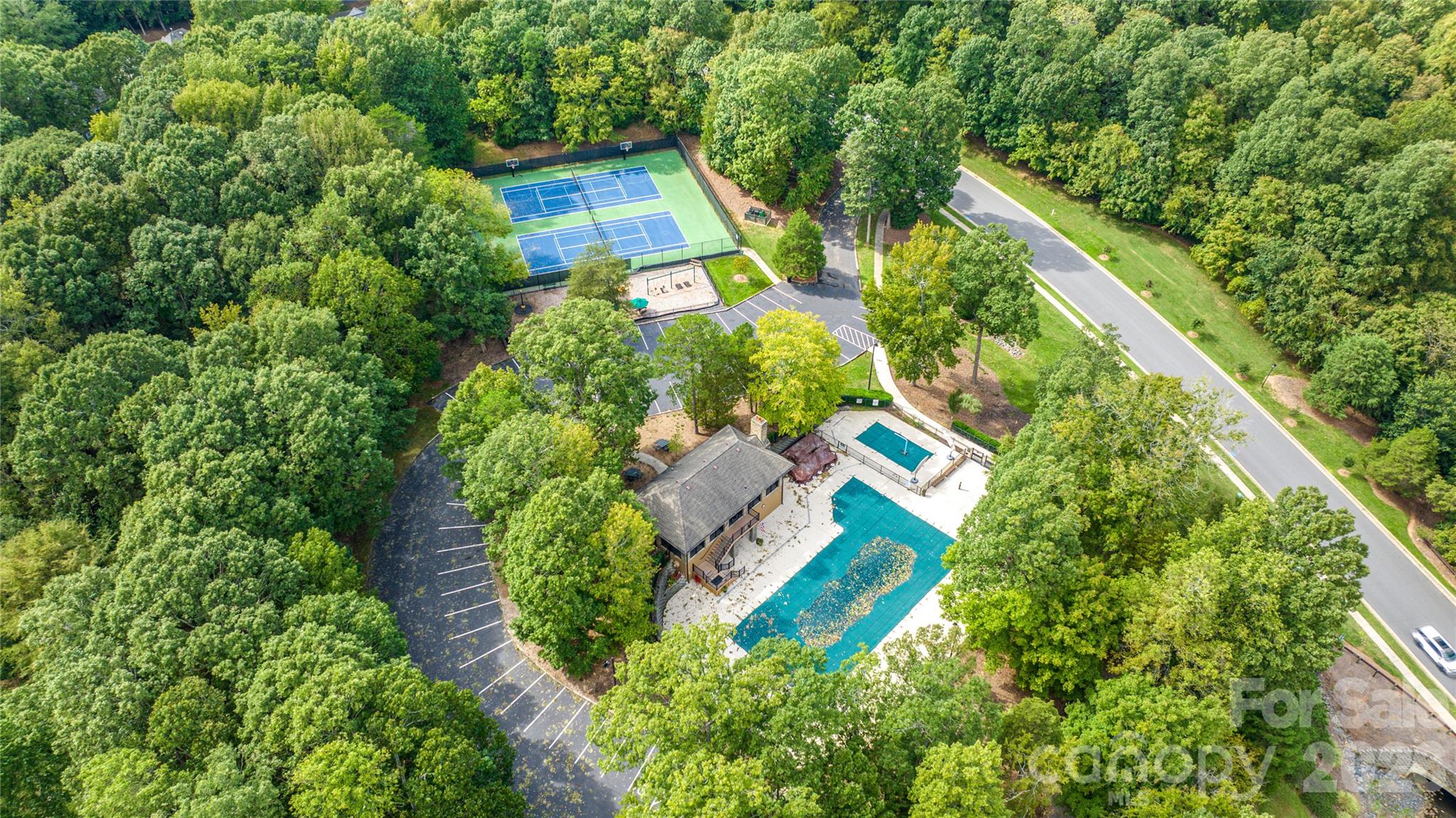 Enjoy sunny days at the community pool, matches on the tennis courts, afternoon fun at the playground, and scenic afternoon strolls along the natural trails. - 11024 Stonepath Lane, Charlotte