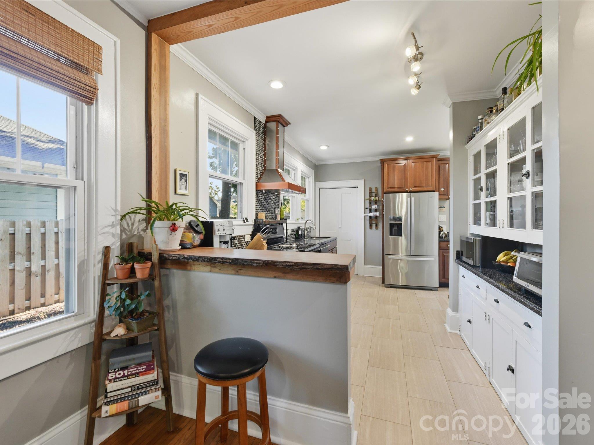Breakfast bar features a live edge wood top - 415 West Boulevard, Charlotte