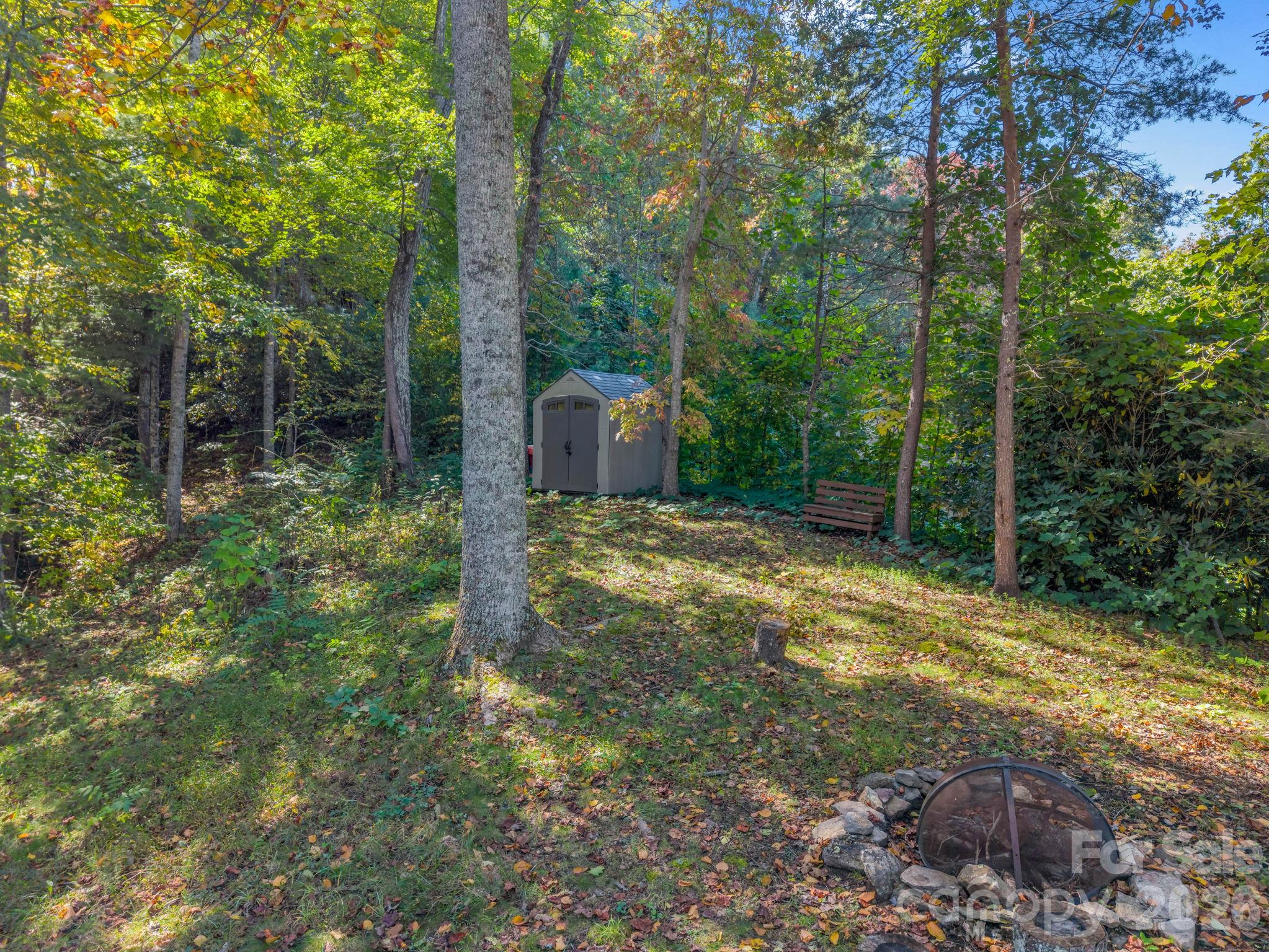 Storage building and firepit area. - 178 Hilltop View Drive, Fletcher