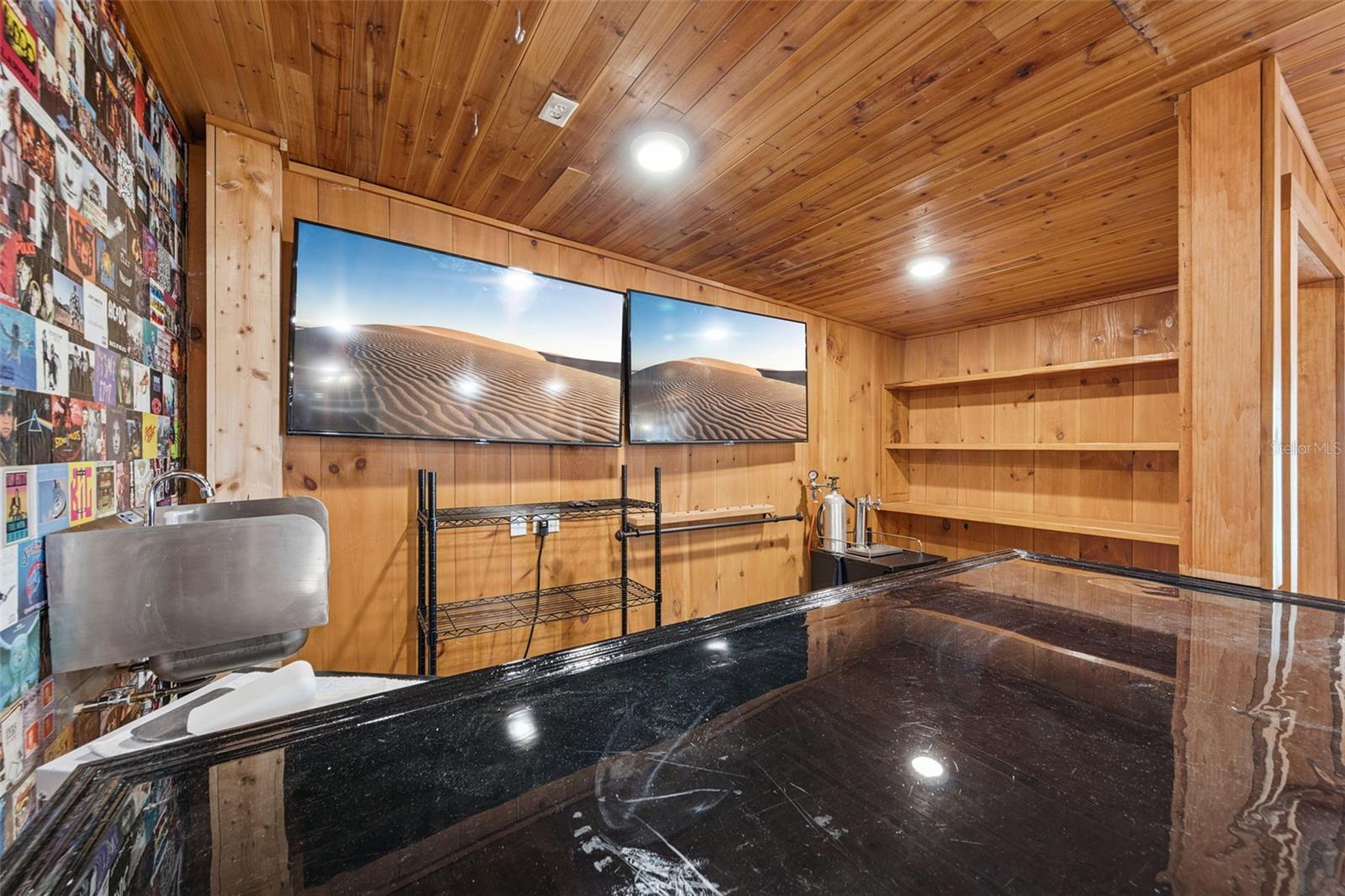 Looking into the bar area with fixed shelving, epoxy bartop and sink with 2 flat screen tv's included. Everything you need to start watching the big game! - 3115 HARGILL DR, ORLANDO