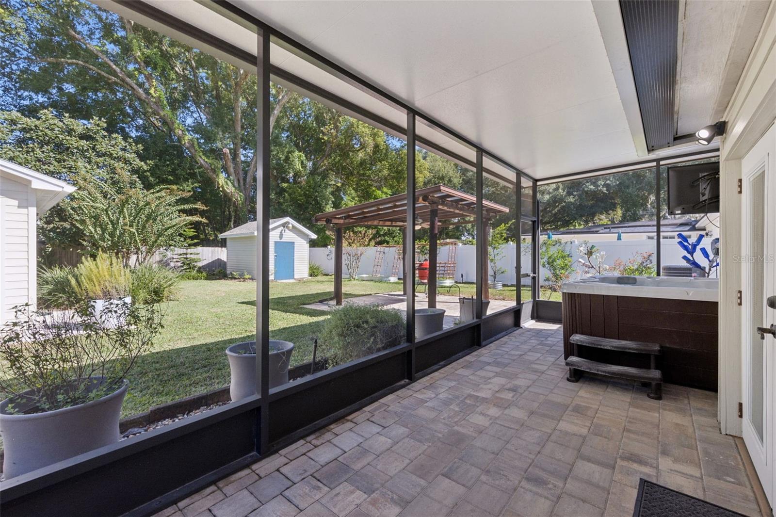 Screen porch views overlooking the hot tub and fully fenced backyard. - 3115 HARGILL DR, ORLANDO