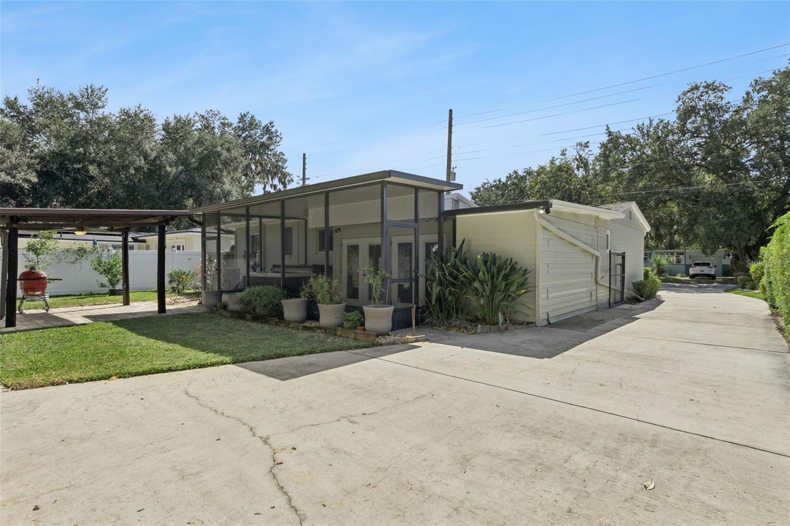Backyard view of the driveway, screen porch and gazebo. - 3115 HARGILL DR, ORLANDO
