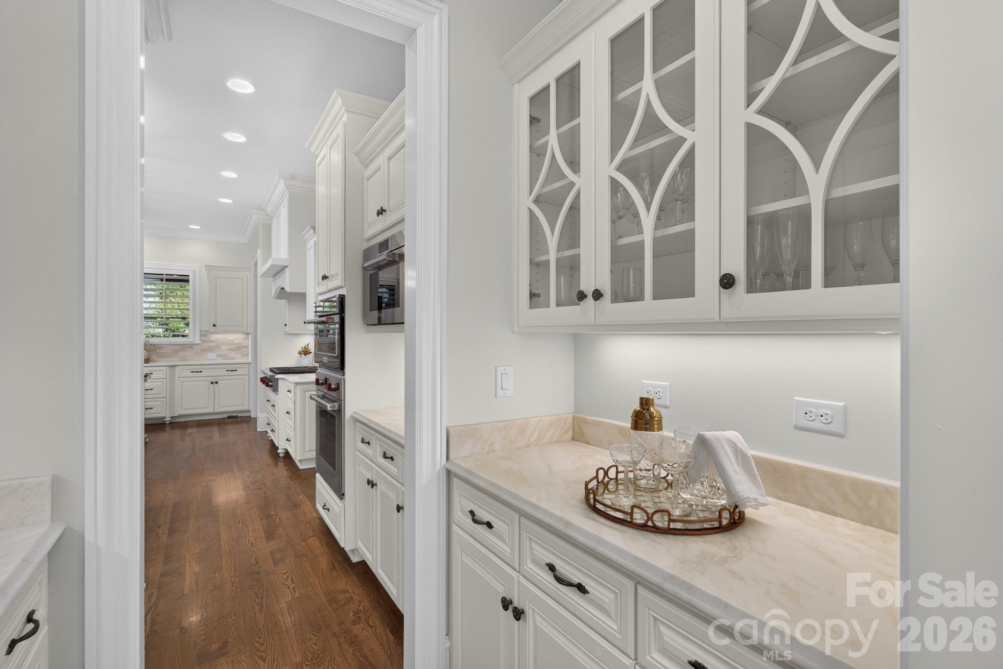 Glass front stemware storage in butler's pantry - 7805 Clovervale Drive, Waxhaw