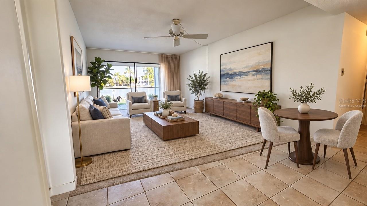 Virtually staged living room and dining area with tile floors, ceiling fan, and sliders to the screened lanai. Photo is virtually staged; furnishings are not included. - 1423 MEDITERRANEAN DR #B, PUNTA GORDA