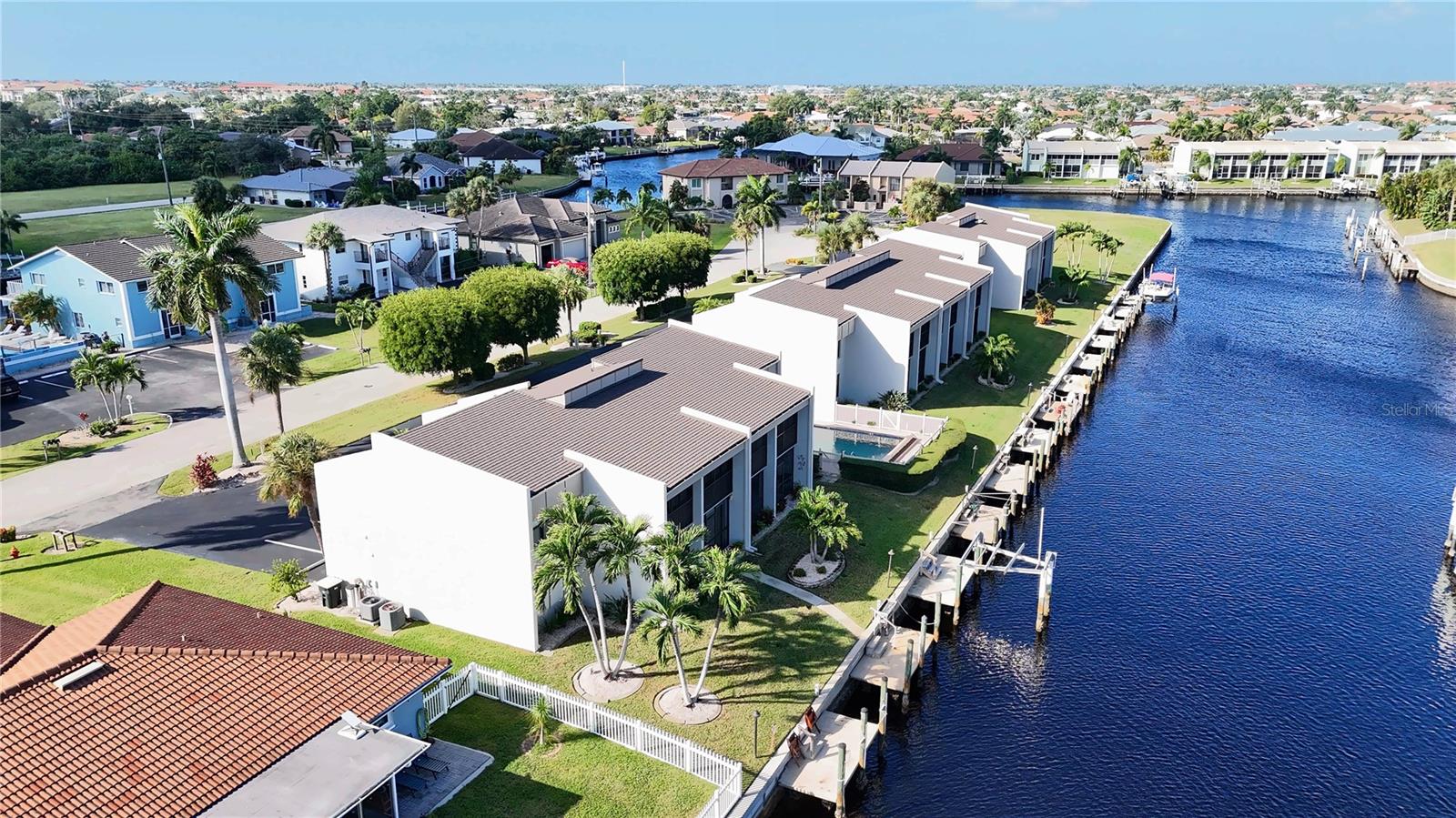 Aerial view of the Punta Gorda canal system showing the condo, its waterfront dock, and the surrounding canal-front neighborhood. - 1423 MEDITERRANEAN DR #B, PUNTA GORDA