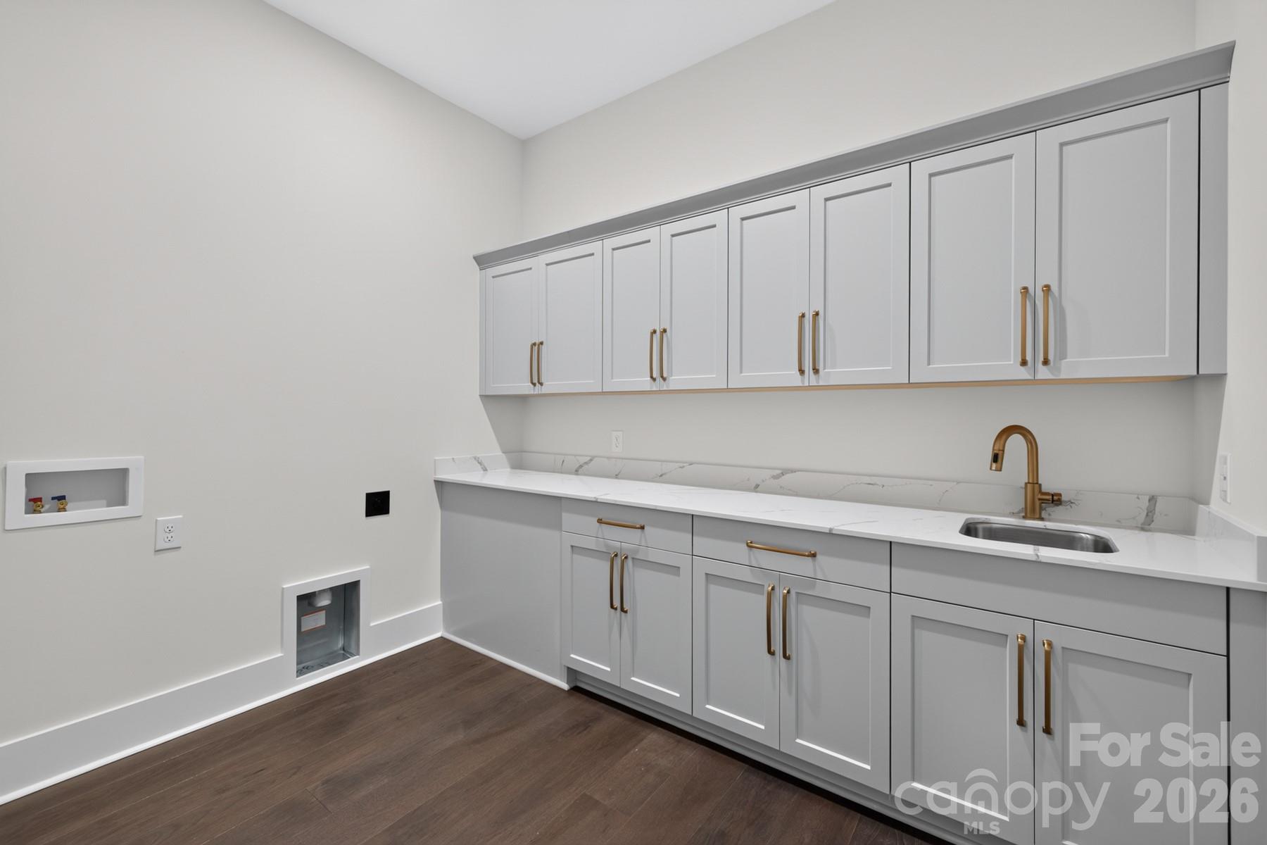 Laundry room with sink and plenty of cabinet storage - 128 Willow View Loop, Davidson