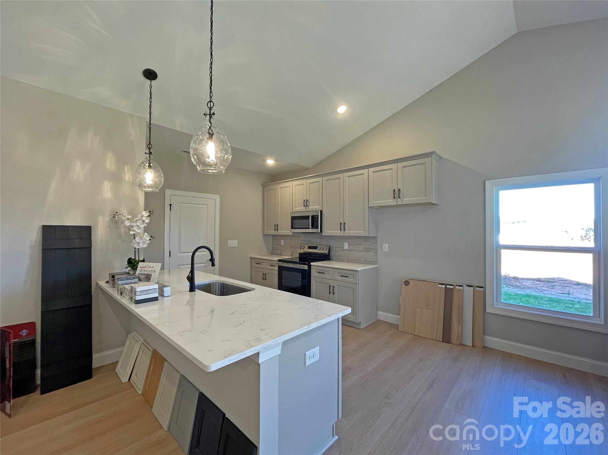 Kitchen with Breakfast Bar - 130 Windstone Crossing Trail, Troutman