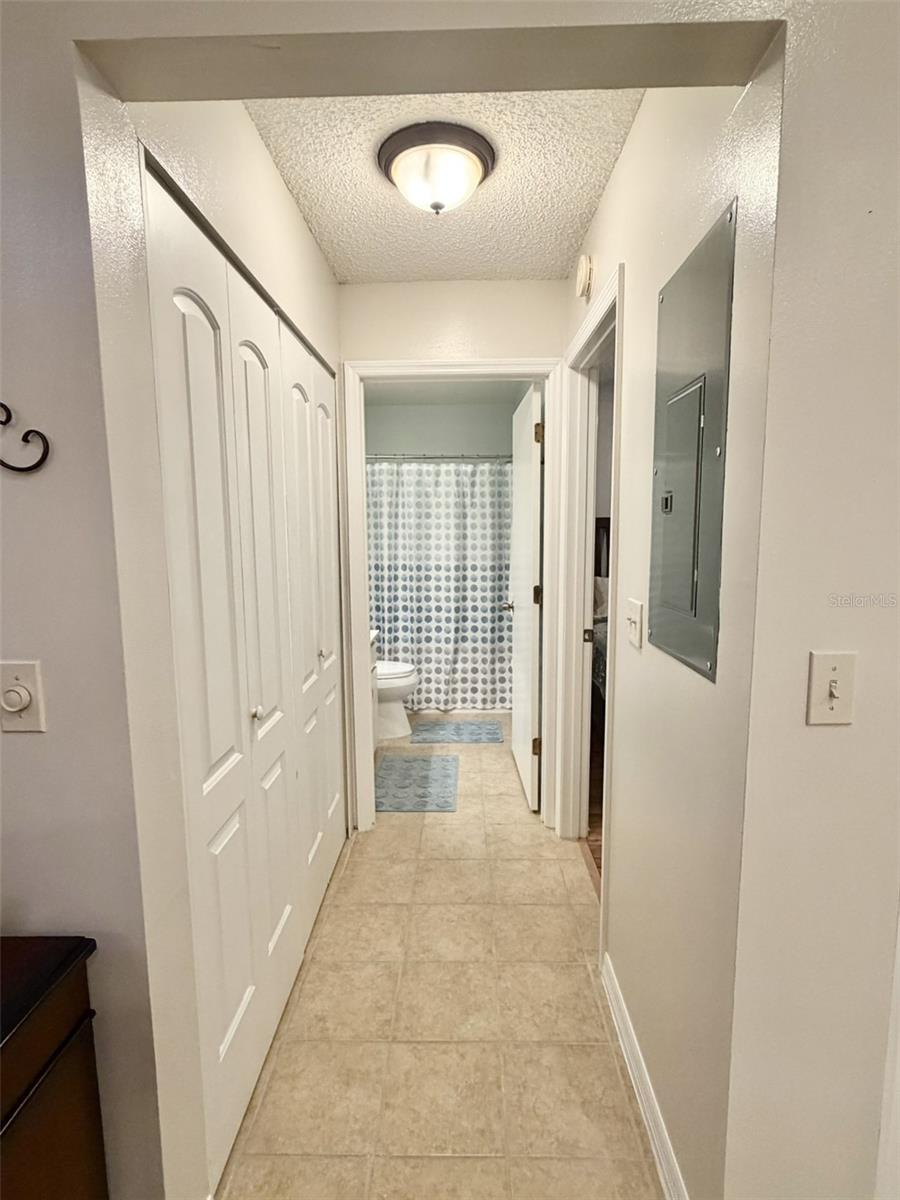 hallway with laundry, guest bedroom and bath - 311 KELSEY WAY #3, SUN CITY CENTER