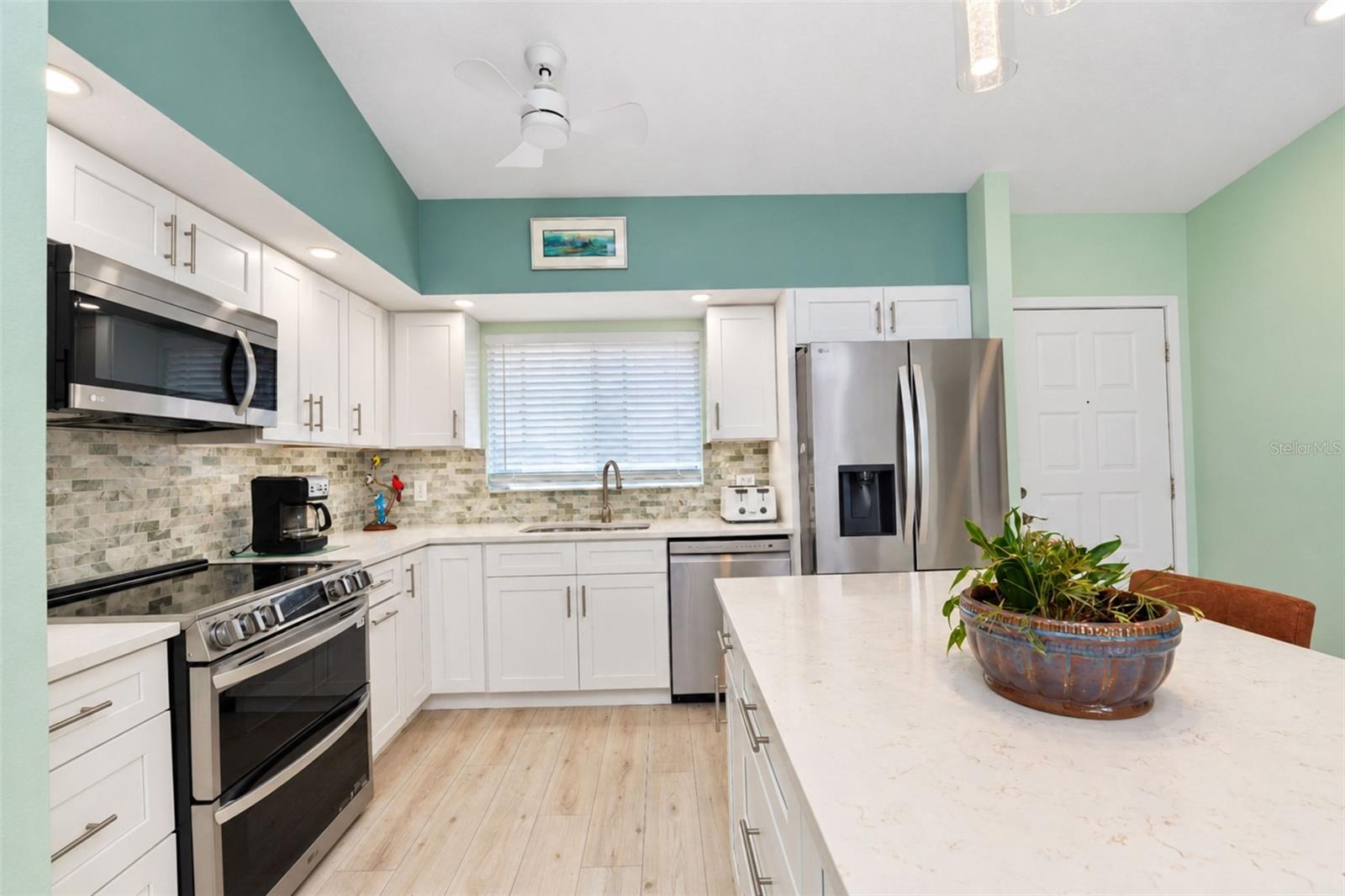 The gorgeous kitchen features an all stainless steel LG appliance package including a French door refrigerator, dishwasher, microwave and range with double ovens & a built-in air fryer. - 6468 HAMLET DR #B, ENGLEWOOD