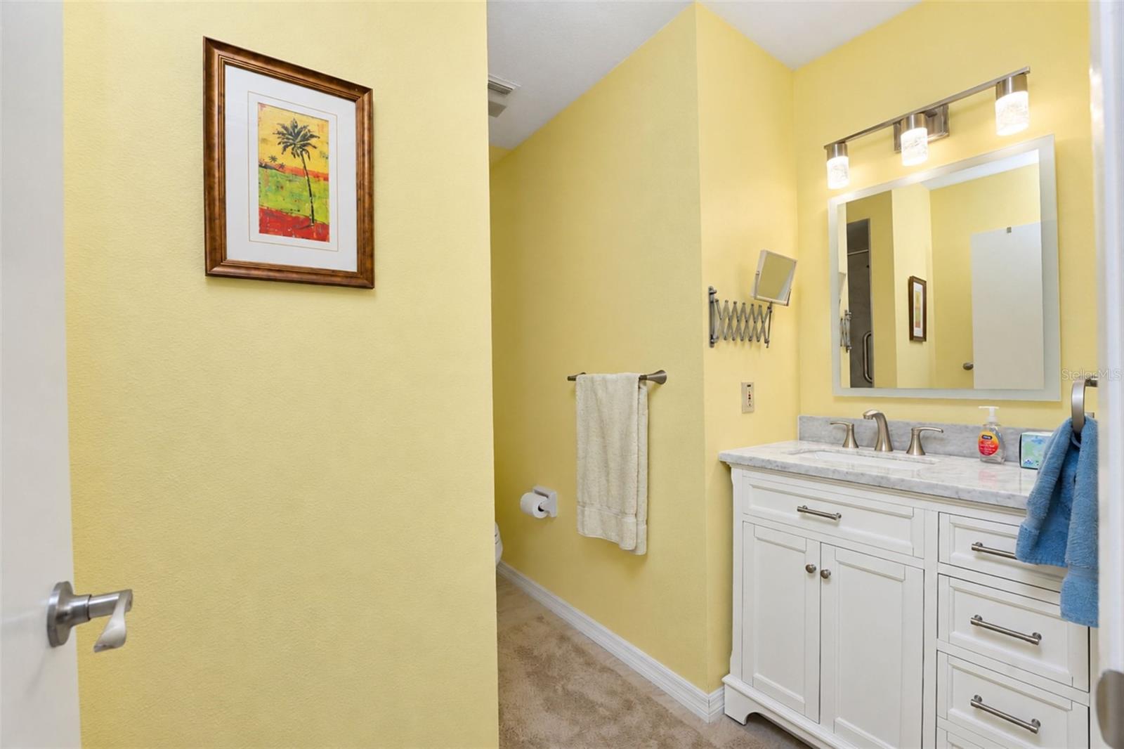The guest bathroom has tiled flooring, new vanity with solid-surface countertop, new "touch" mirror, new lighting & many more updates! - 6468 HAMLET DR #B, ENGLEWOOD