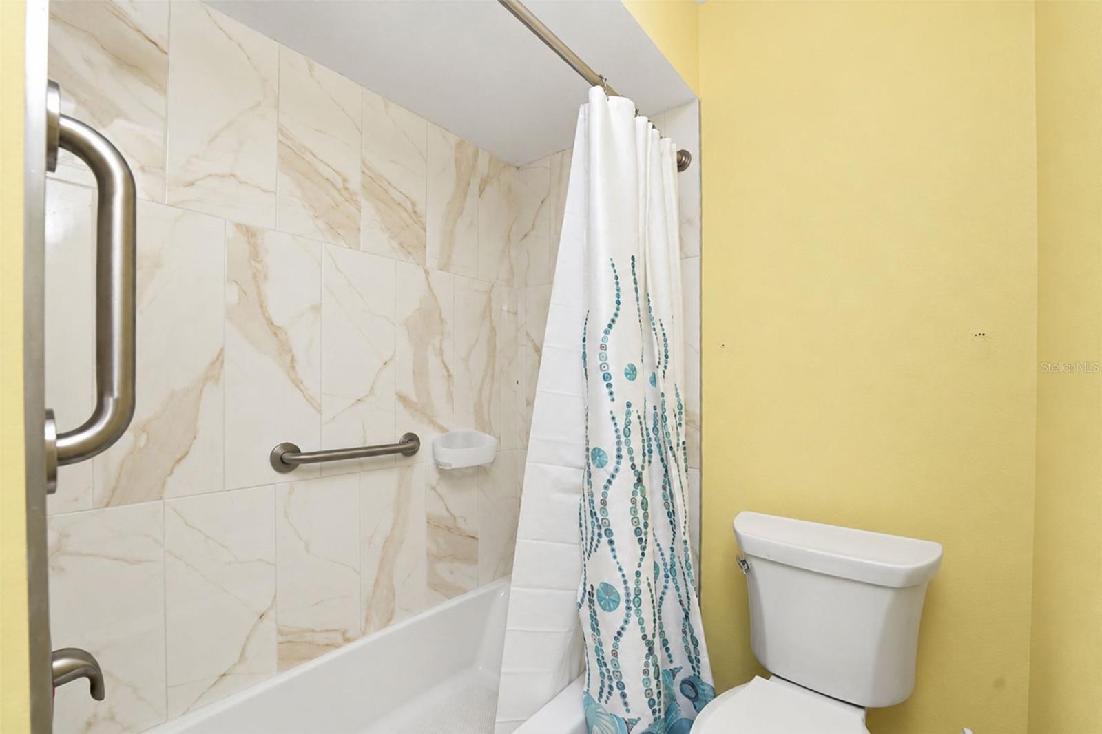 The guest bathroom features a tub/shower combo with a new tub & new wall tile. - 6468 HAMLET DR #B, ENGLEWOOD