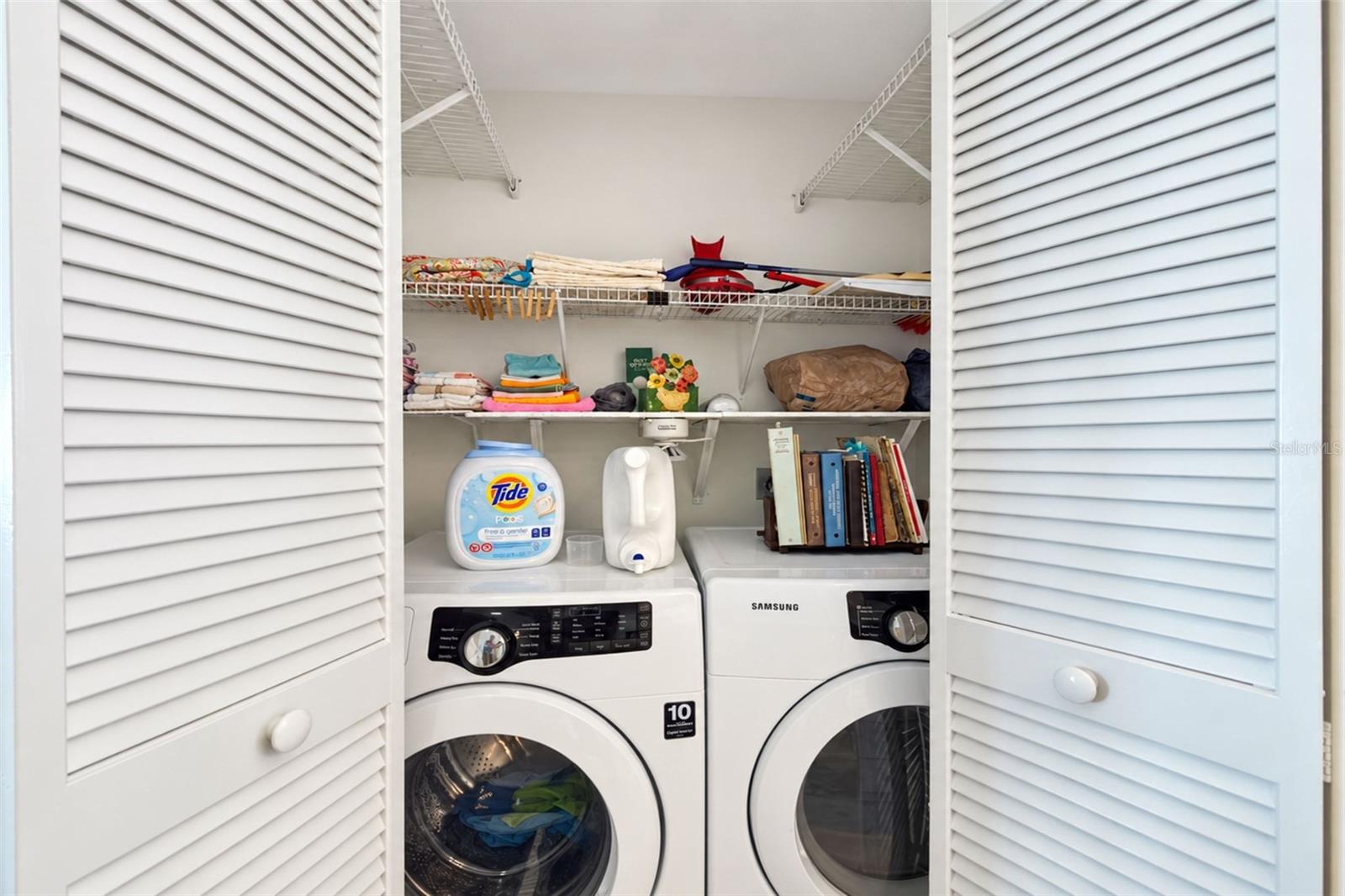 The inside laundry closet features a Samsung front load washer & dryer. - 6468 HAMLET DR #B, ENGLEWOOD