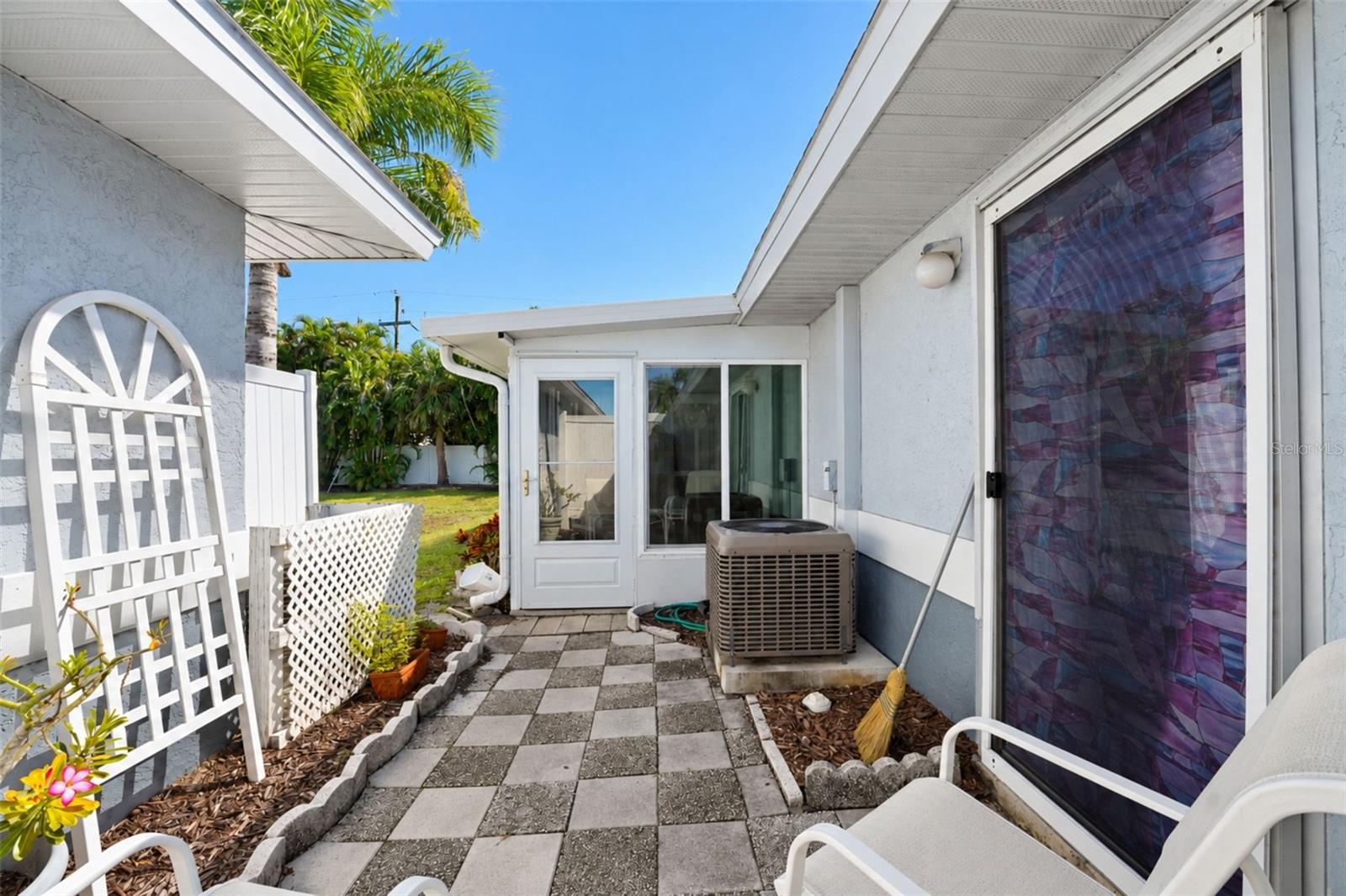 The rear patio has access from the primary bedroom and Florida room. - 6468 HAMLET DR #B, ENGLEWOOD