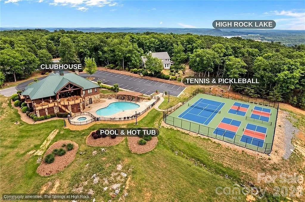 Aerial of the clubhouse, pool, hot tub, and tennis and pickleball courts. - 268 Lot43 Sirocco Drive W, Denton