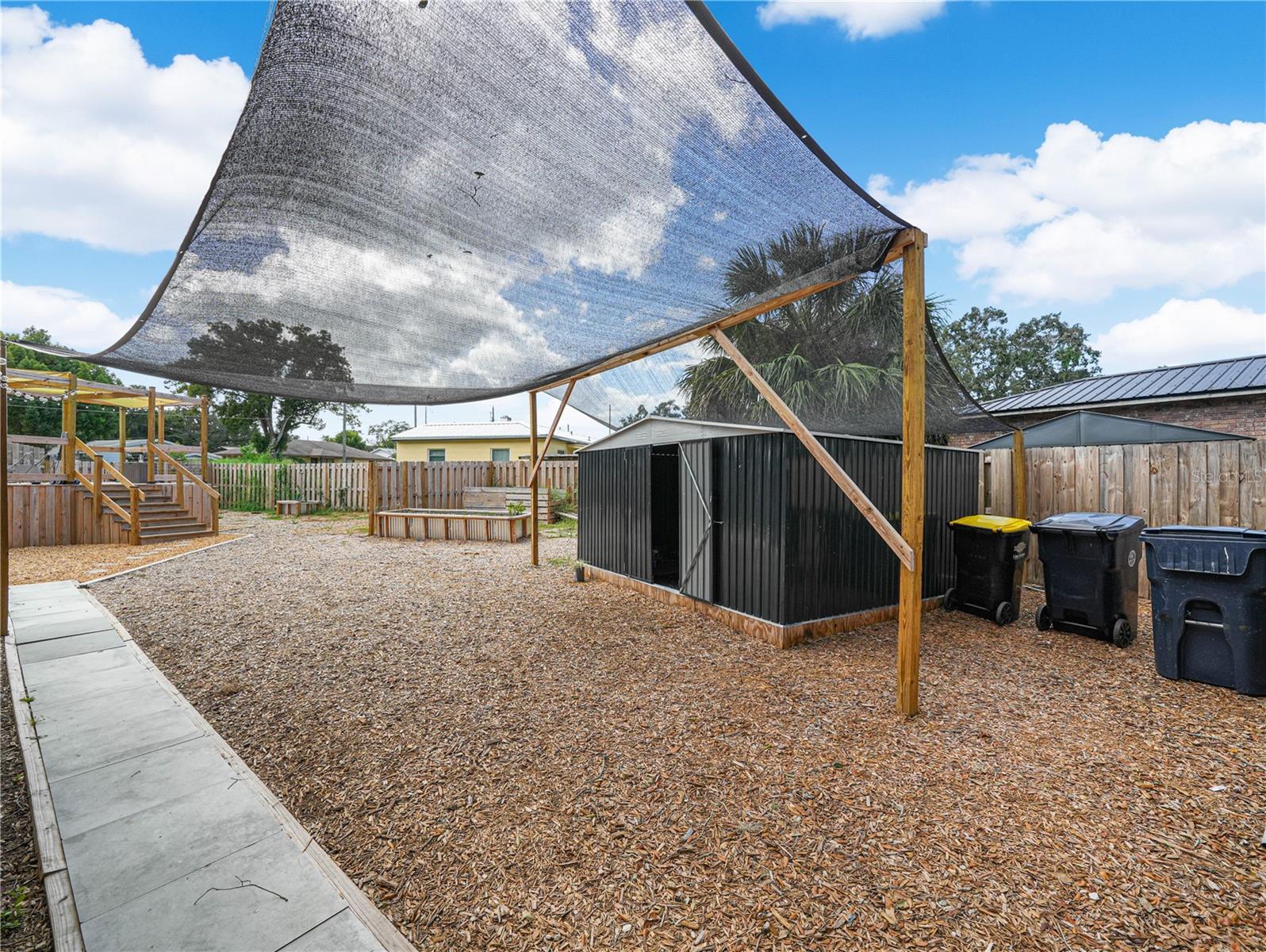 Fully fenced back yard with pool, deck, shed and raised garden beds - 310 RICO WAY, AUBURNDALE