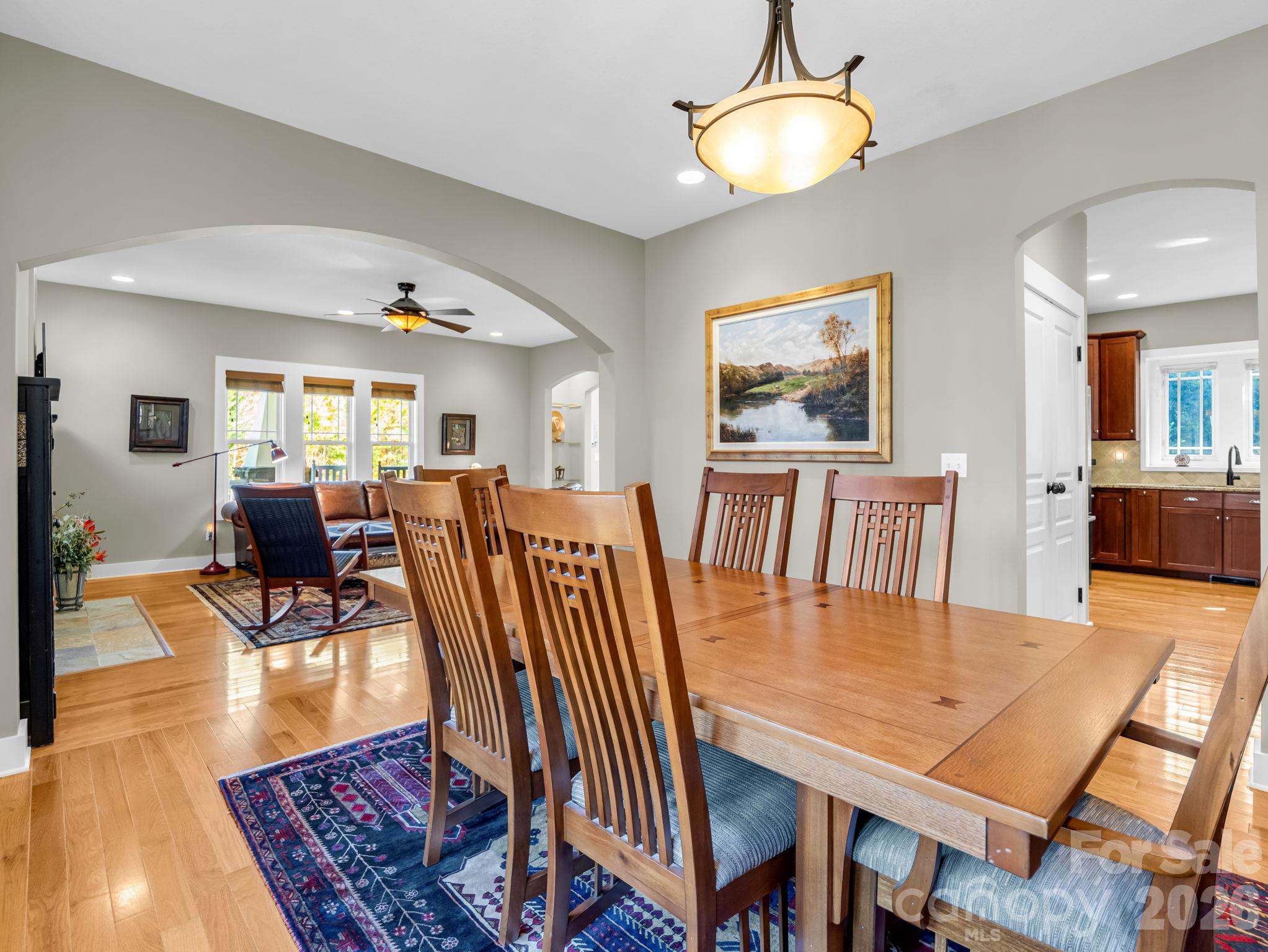 Arched doorway from living room into dining room, kitchen to the right (pantry just through the door) - 376 Scarlet Tanager Court, Arden