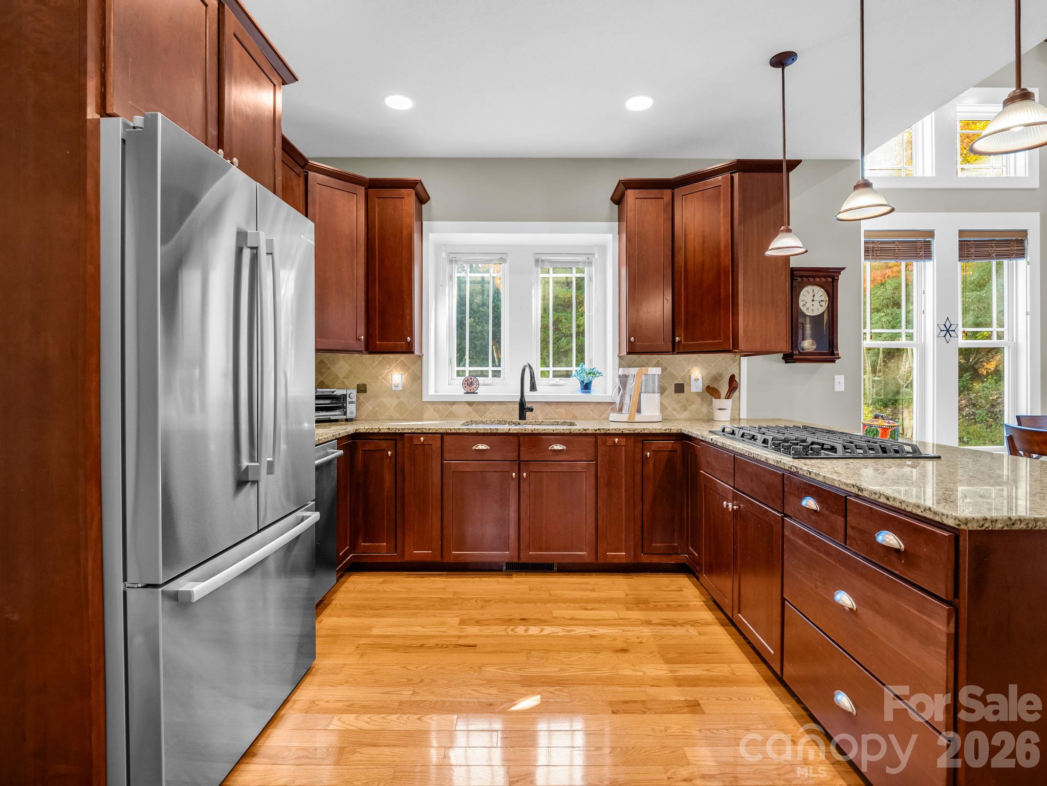 Beautiful custom cabinets, oak hardwood floors, granite counters and stainless steel appliances - 376 Scarlet Tanager Court, Arden