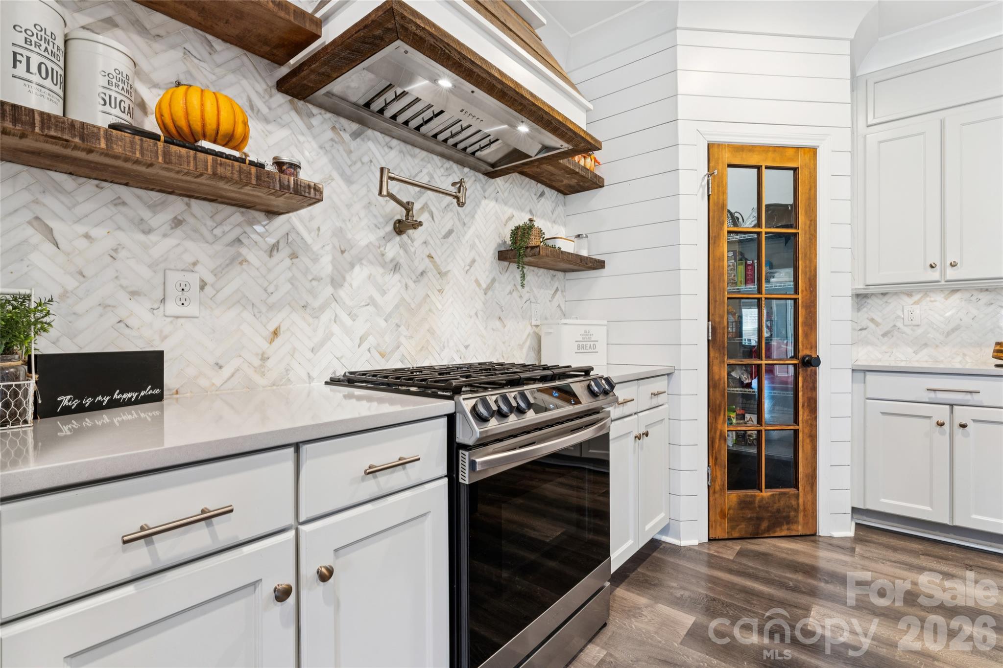 A cooks dream. Gas stovetop, hood vent, pot filler. Designer marble backsplash - 2014 Seefin Court, Indian Trail