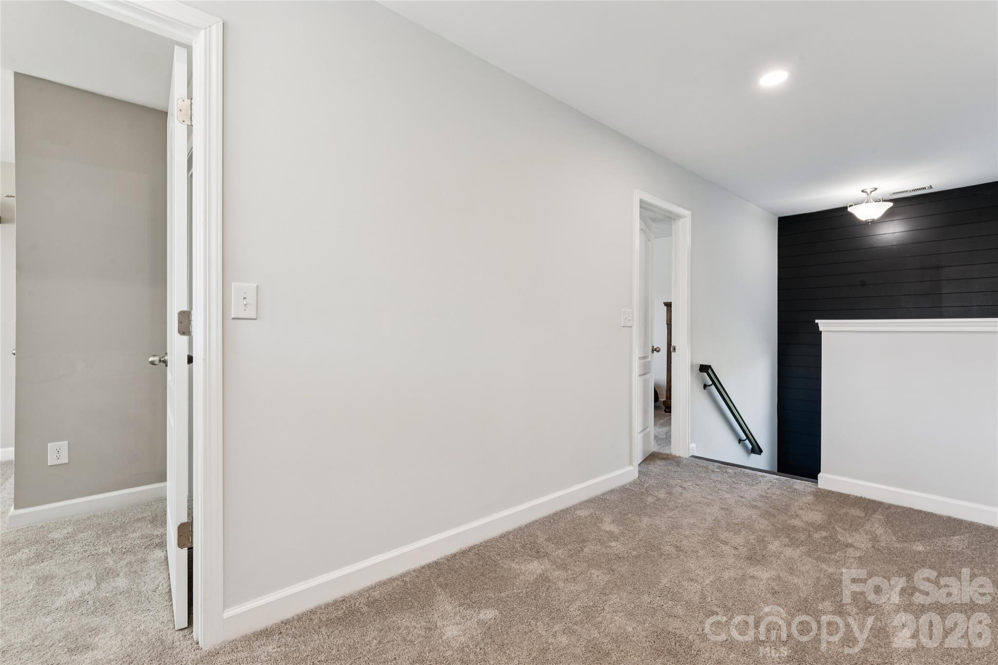 Wide landing upstairs. No carpet on stairs, custom wall accent. - 2014 Seefin Court, Indian Trail