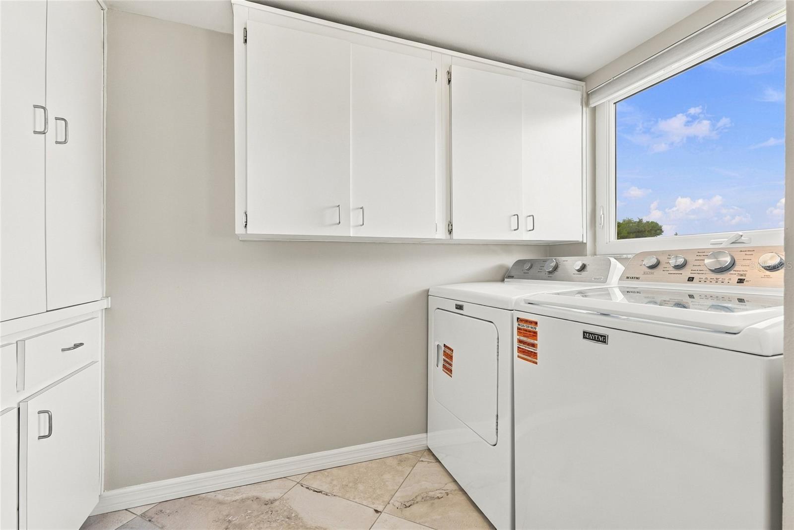 Inside laundry room with loads of storage cabinets - 2228 SWEDISH DR #22, CLEARWATER