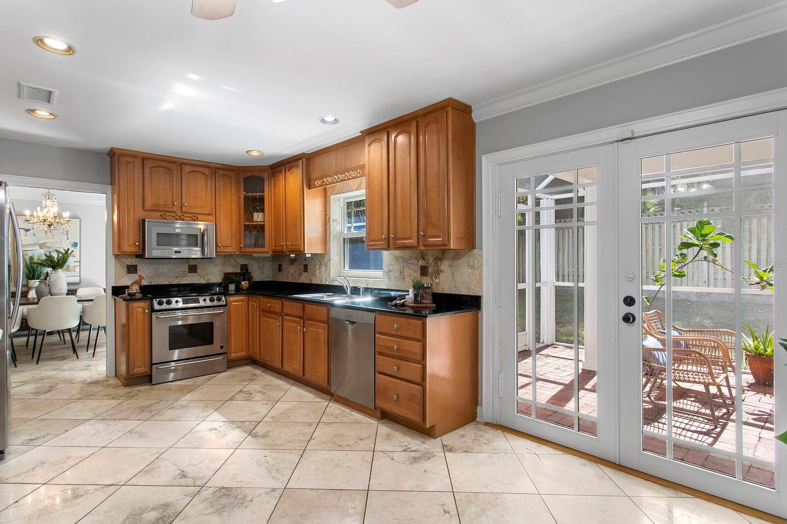 The closed lanai is just to the right of the kitchen and you can see the formal dining room. - 2930 W BAYSHORE CT, TAMPA