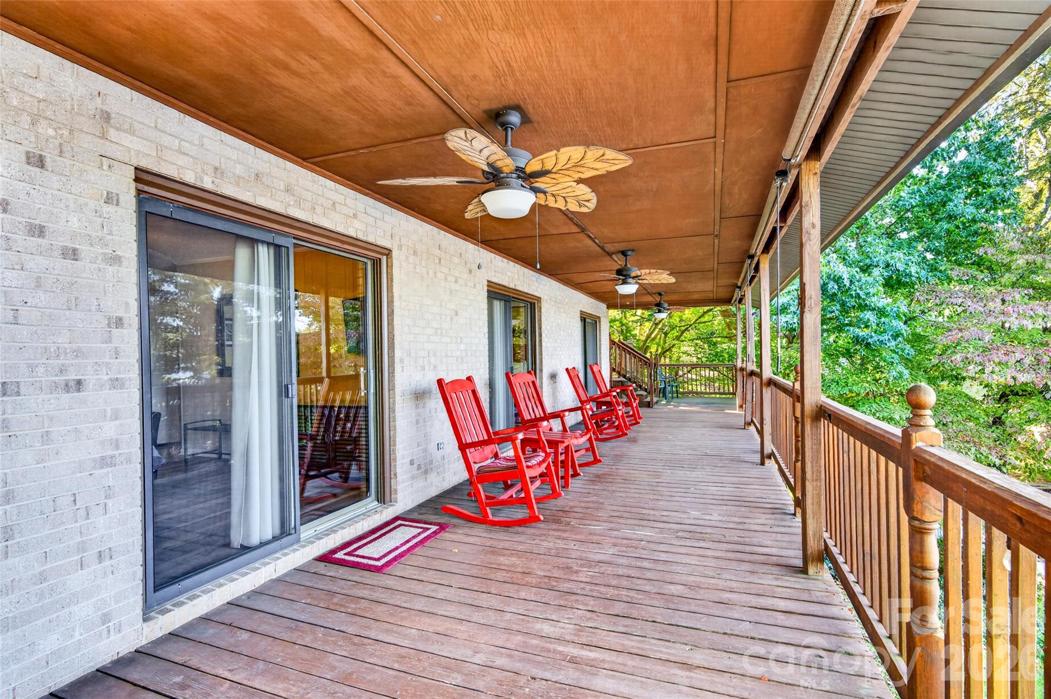 Covered Balcony across the back of the home, 3 of the upstairs bedrooms have a sliding door out to the balcony - 188 Paradise Peninsula Road, Mooresville