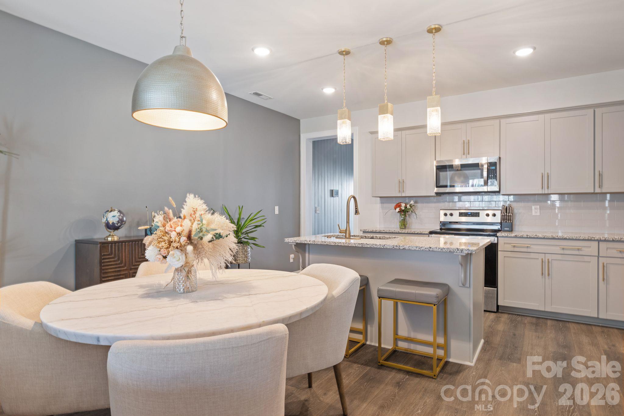 Stylish upgraded fixtures enhance the dining room and kitchen. - 42 Walnut Springs Drive, Asheville