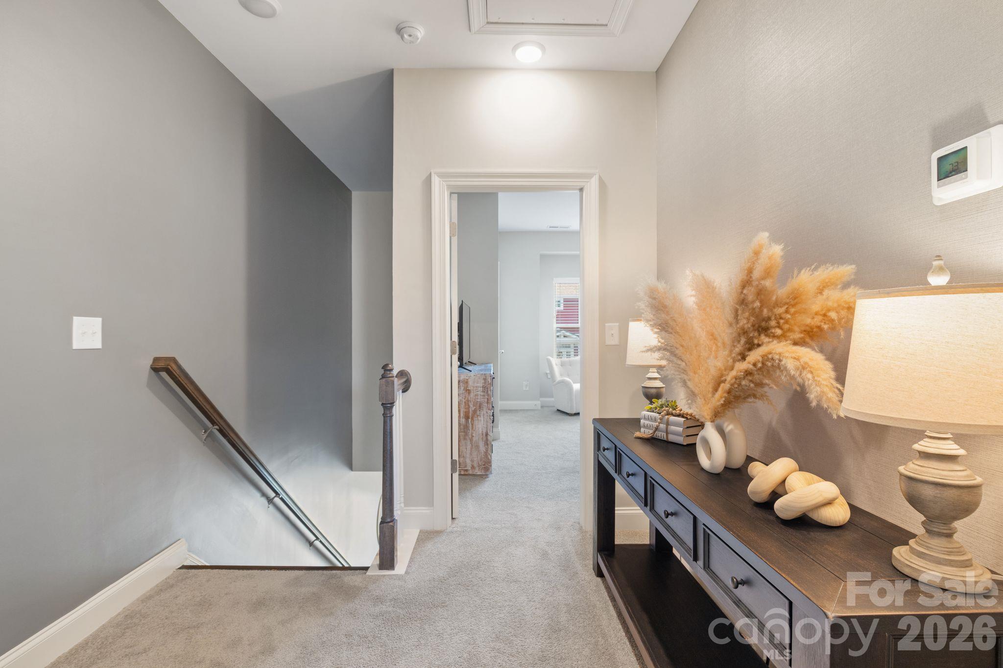 Upper level includes 2 large bedrooms with walk-in closets joined by a full bathroom. Also, extra storage in pull-down attic space. - 42 Walnut Springs Drive, Asheville