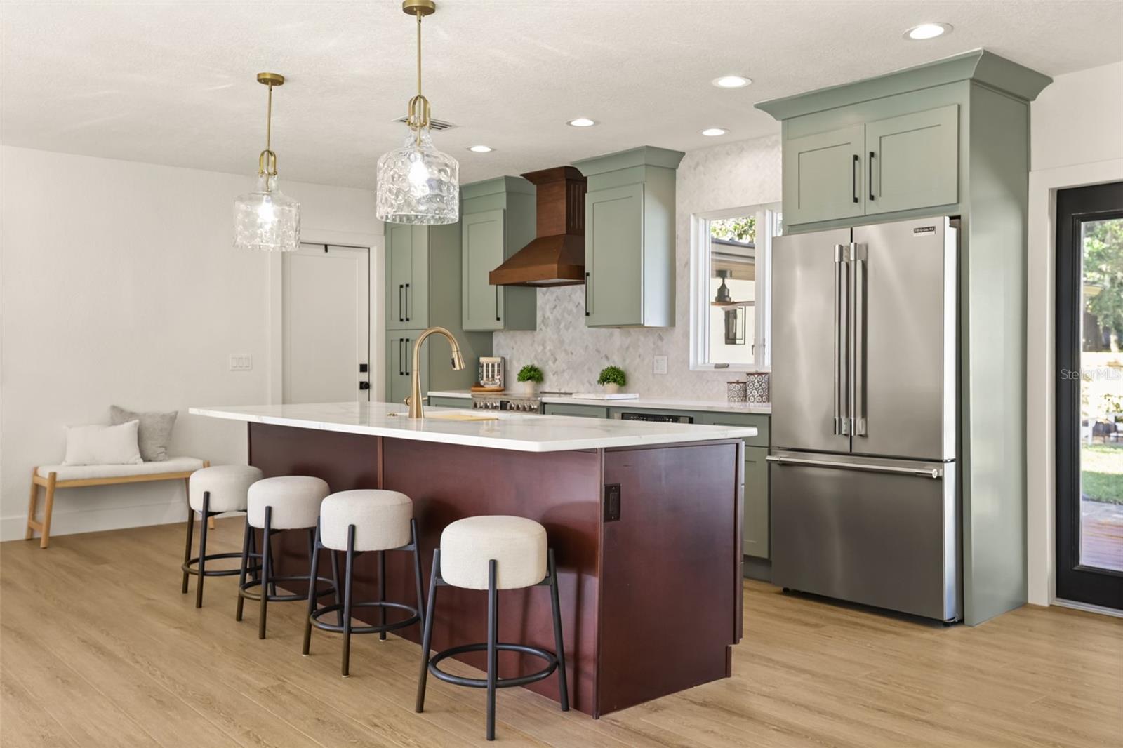 Chef's kitchen with large island and leading out to outside deck. - 512 MAYFAIR CIR, ORLANDO