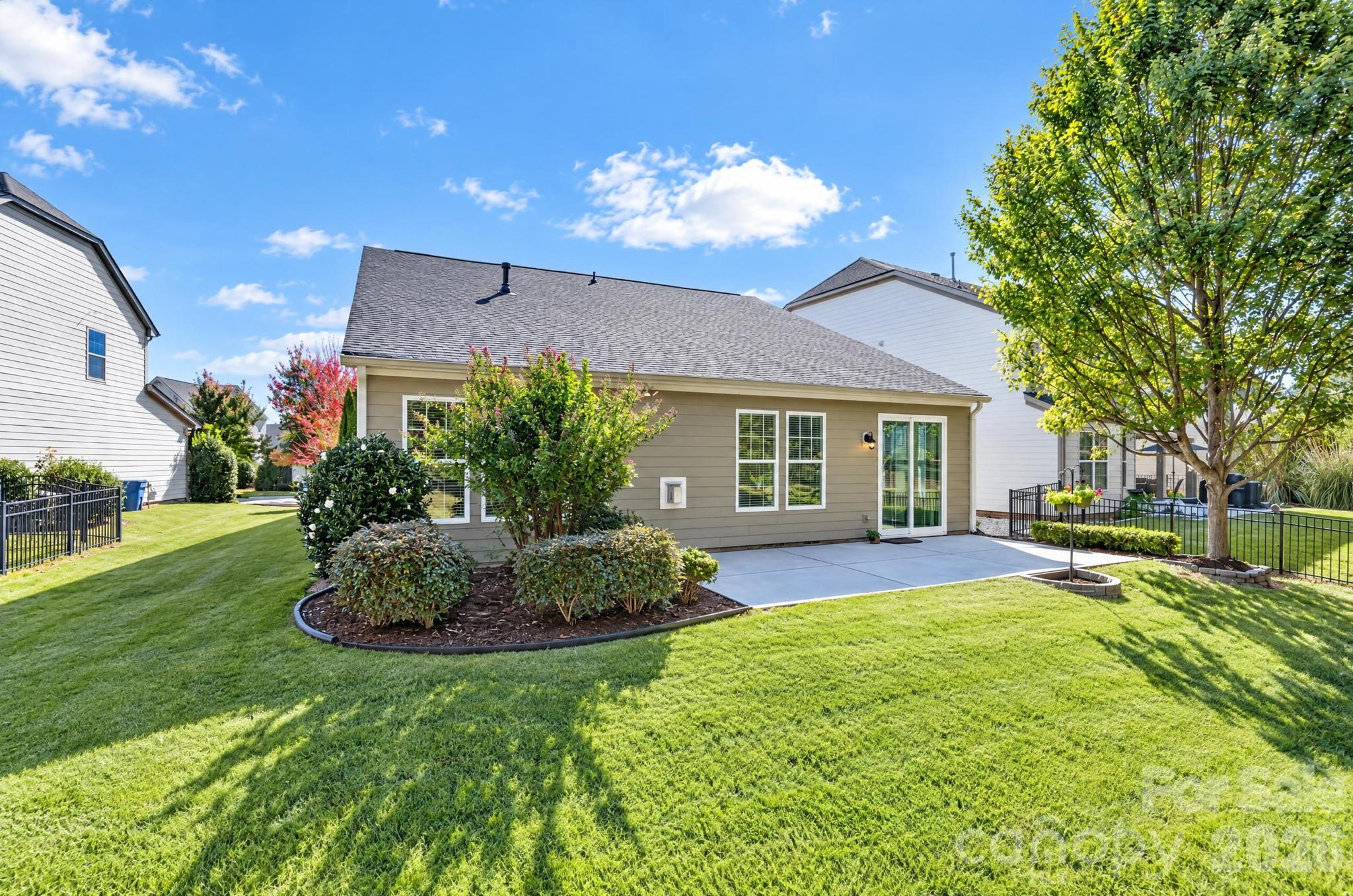 Notice the double-sized patio to better enjoy your backyard, and the thoughtfully-chosen landscaping accents. - 217 Blossom Ridge Drive, Mooresville