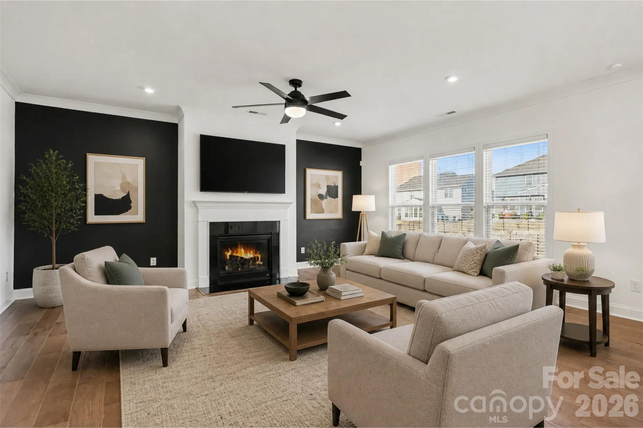 Virtually Staged Family Room with Accent Walls, Gas Fireplace, Updated Ceiling Fan and LVP Flooring. - 11016 Larkslea Lane, Charlotte