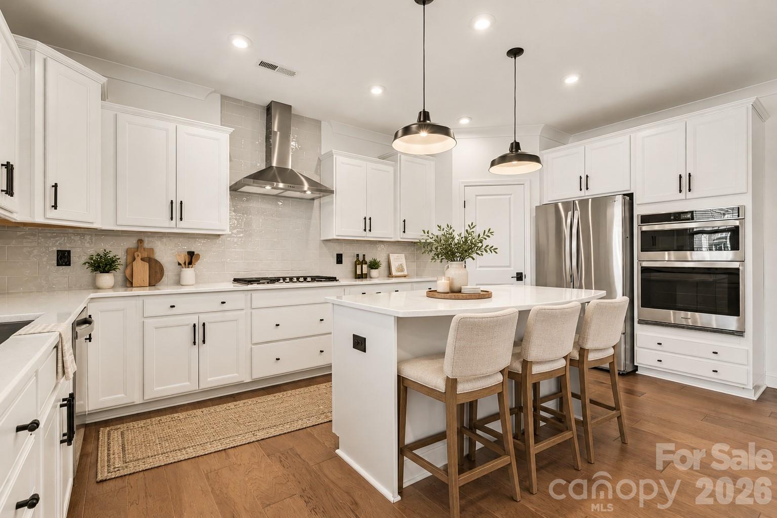 Virtually Staged Kitchen with Freestanding Island, Stainless Steel Appliances, Gas Range, Tile Backsplash & Pantry. - 11016 Larkslea Lane, Charlotte