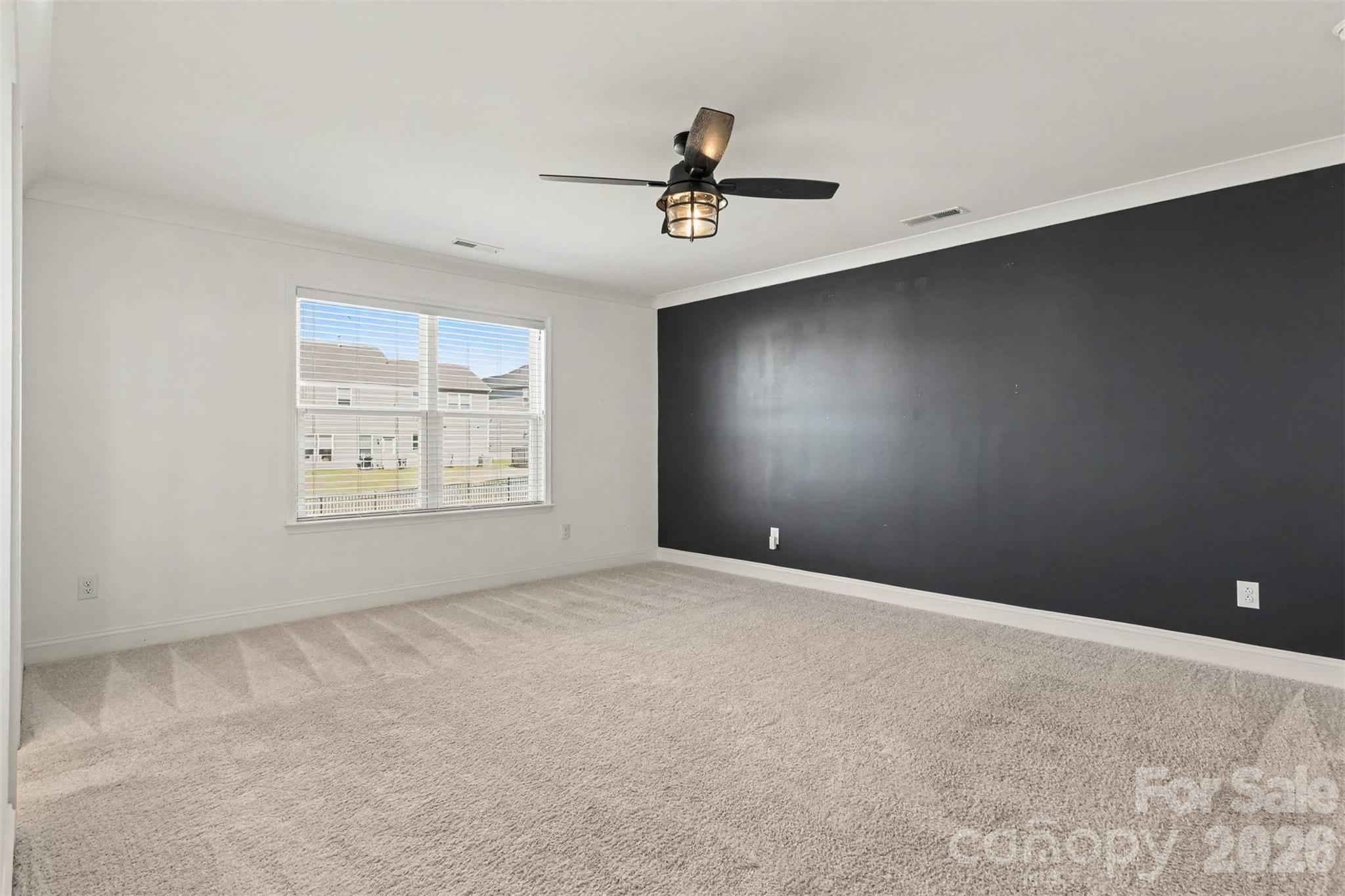 Primary Suite Space W/ Upgraded Ceiling Fan Light, Accent Wall, & Carpet. - 11016 Larkslea Lane, Charlotte