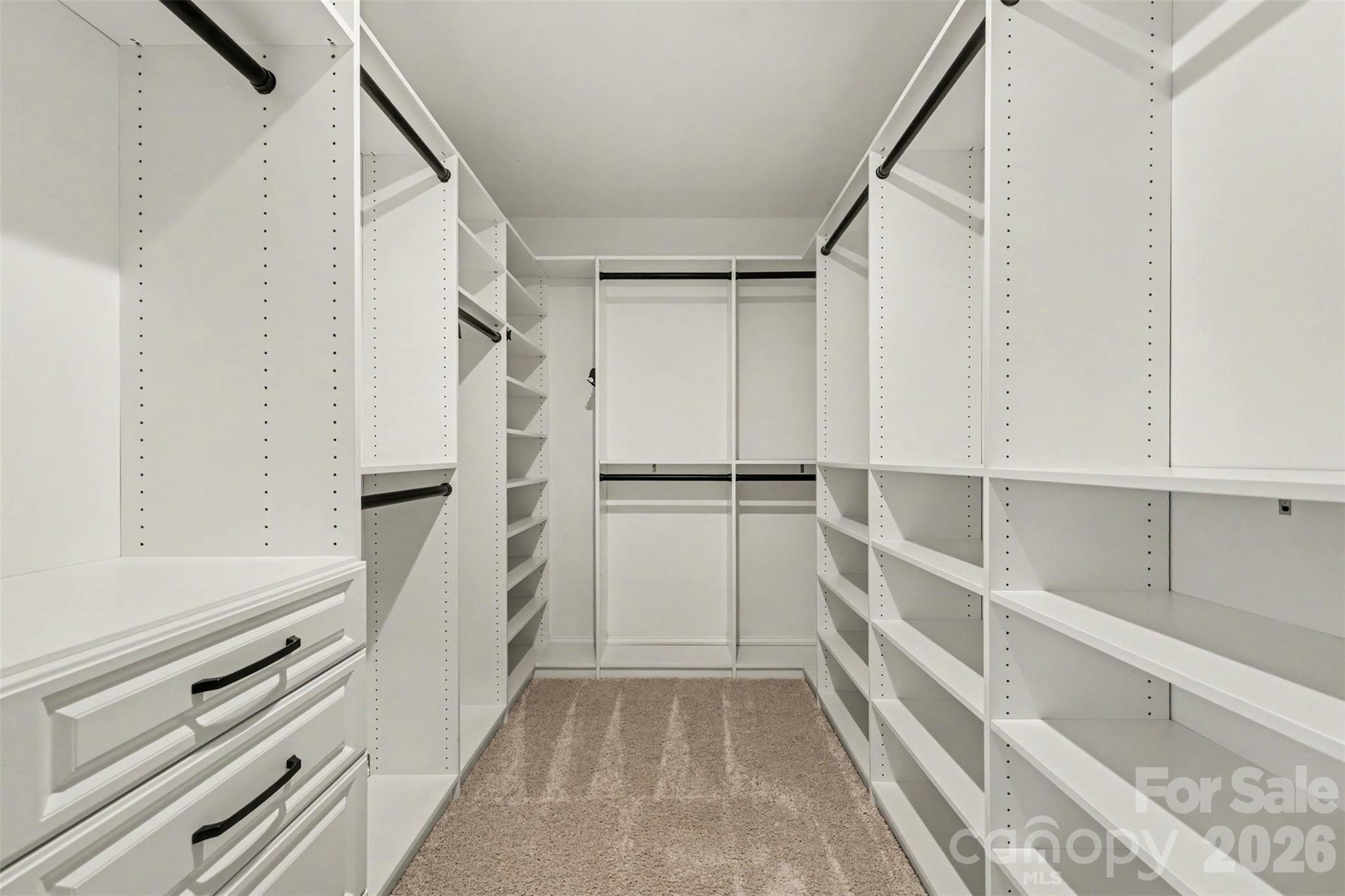 Large Primary Bedroom Wal- In Closet with Custom Storage System. - 11016 Larkslea Lane, Charlotte