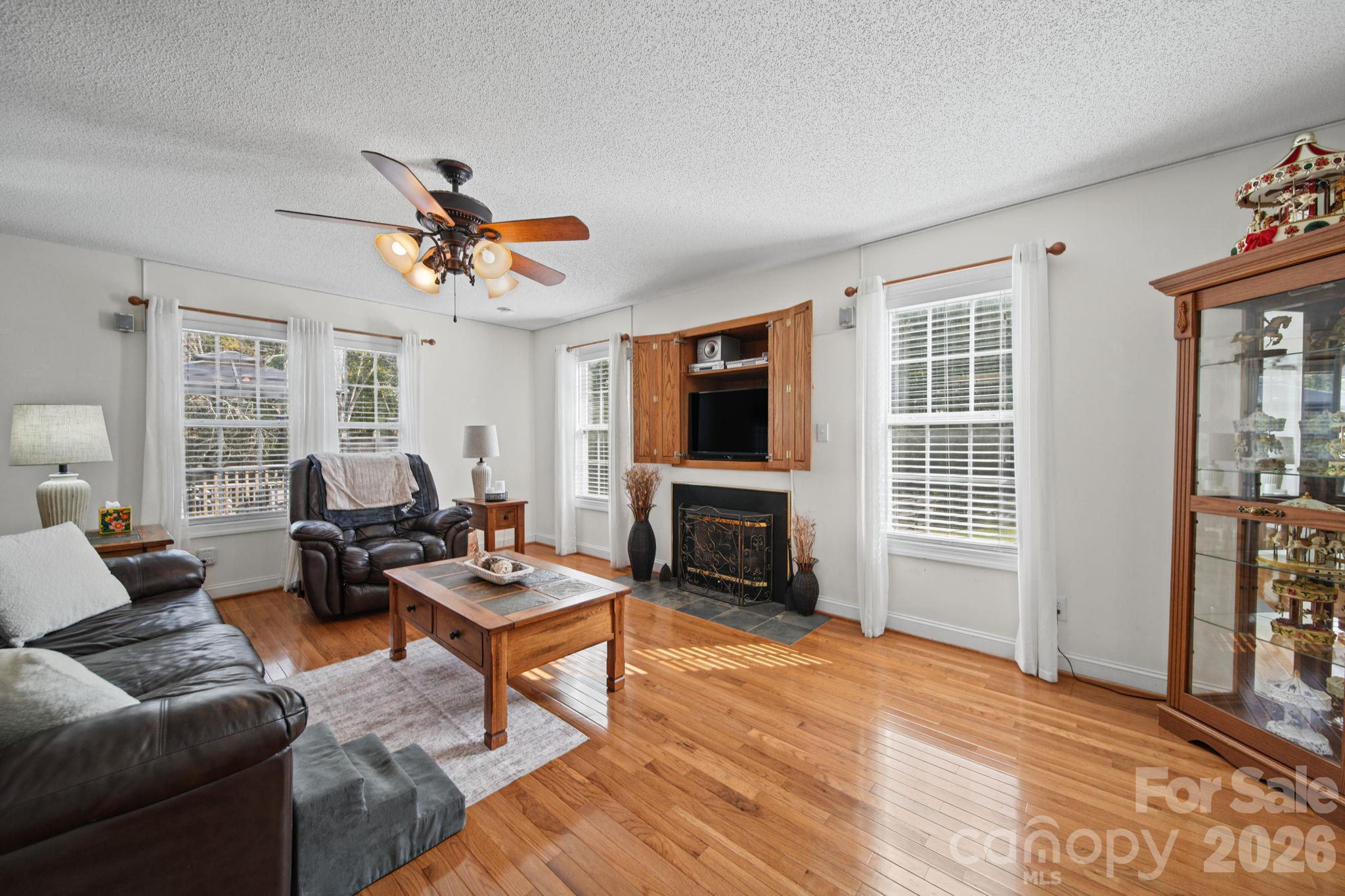 Living room with pre-engineered hardwood floors - 6717 Luther Lane, Monroe
