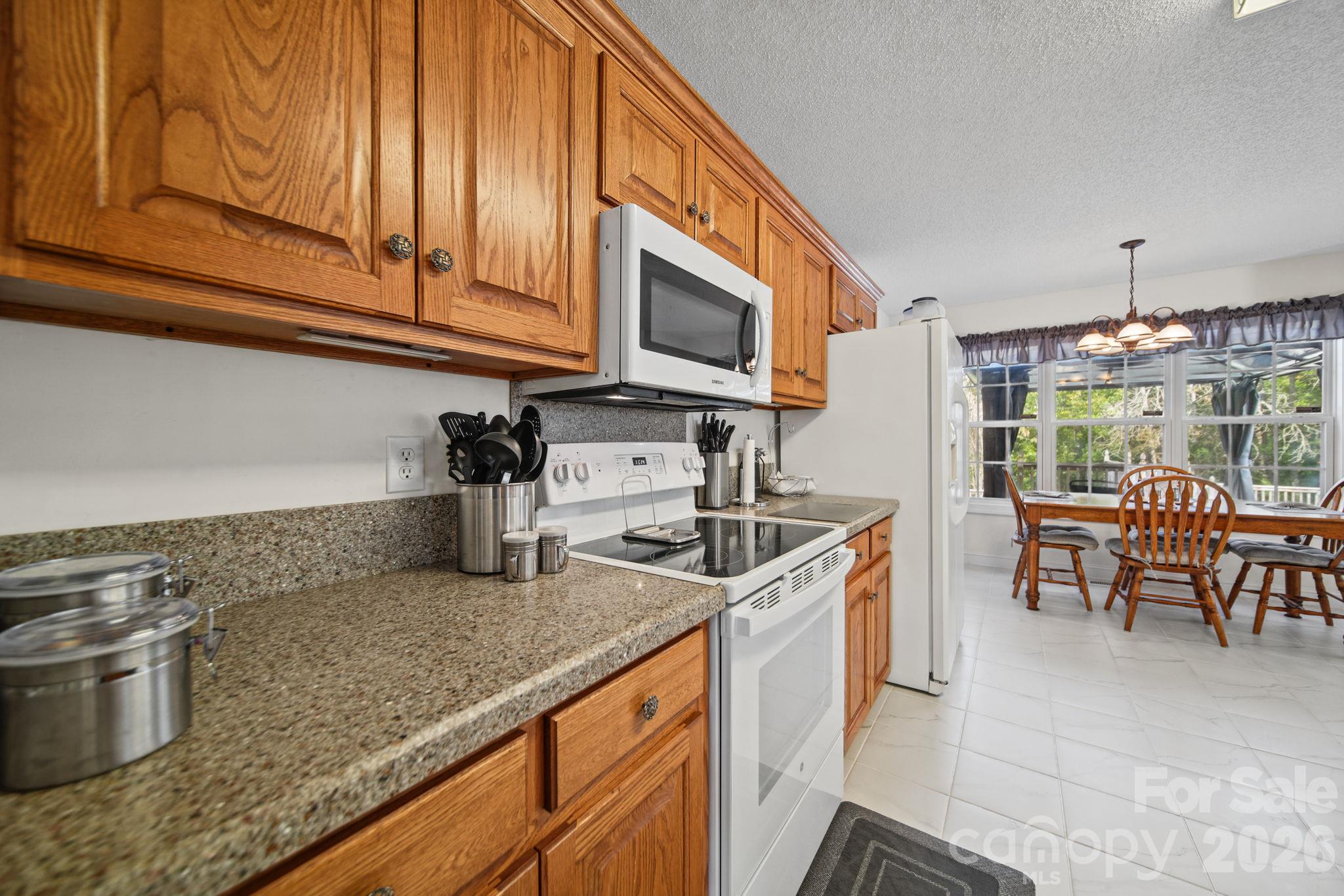 Corian countertops with white appliances - 6717 Luther Lane, Monroe