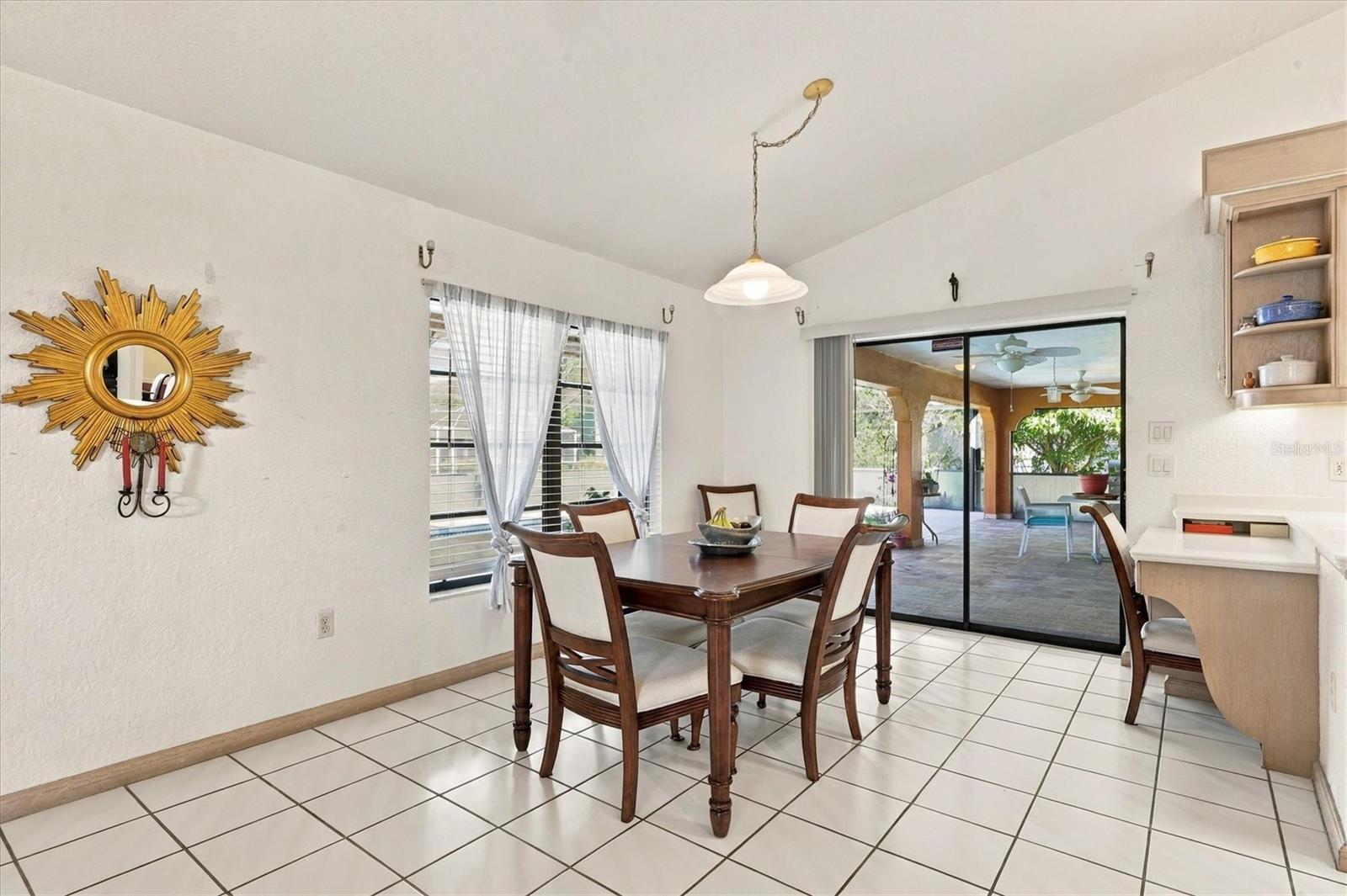 Dining space off the kitchen with pool views and built in desk. - 175 NORMAN ST, PORT CHARLOTTE