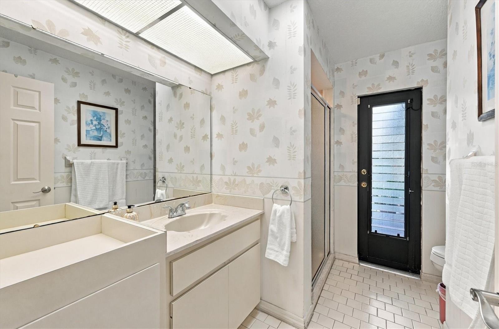 Guest bath with pool access. - 175 NORMAN ST, PORT CHARLOTTE